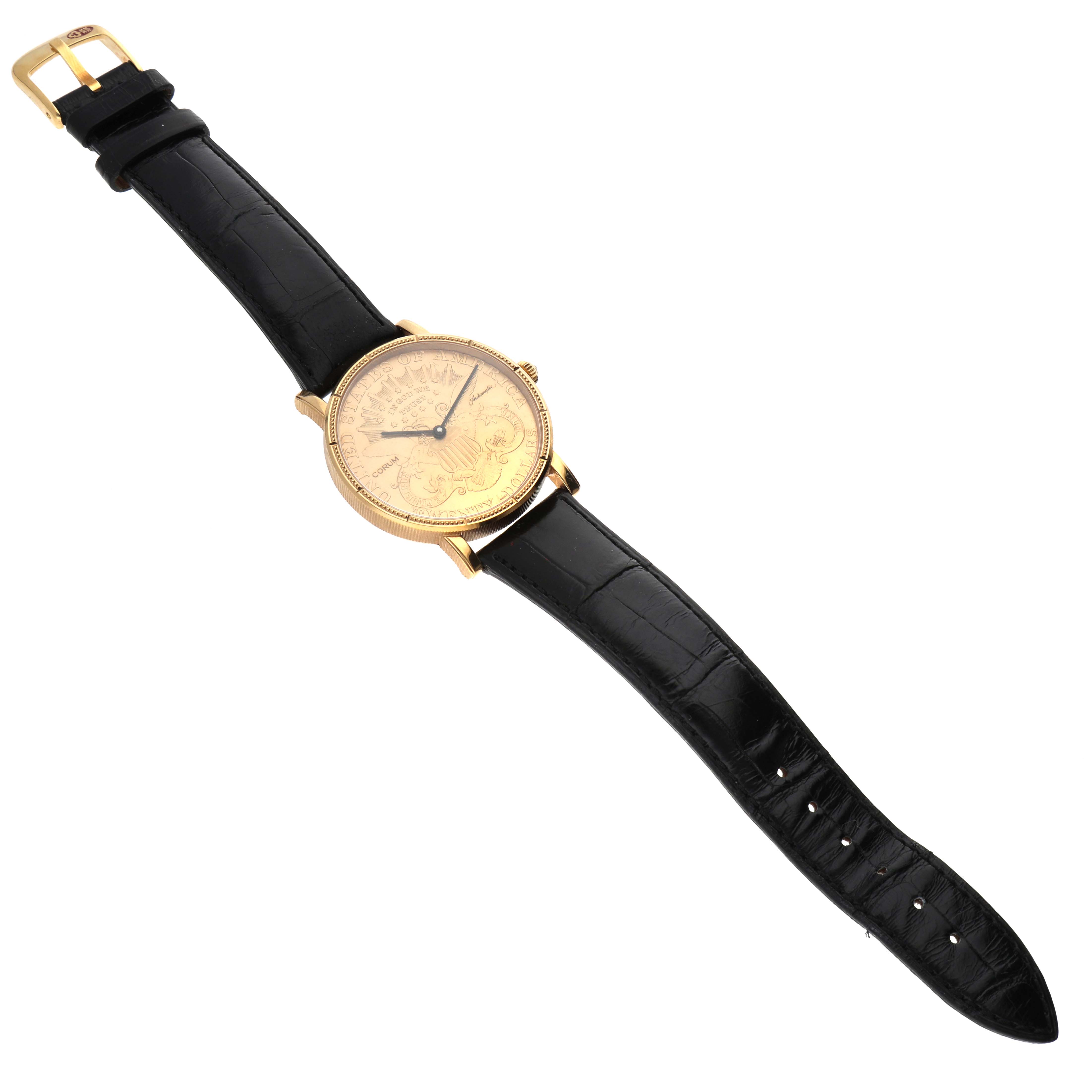 The Corum Coin Watch Men's Yellow Gold Champagne Dial Men's Yellow Gold Champagne Dial model is shown from a top-down angle, displaying its black leather strap and gold coin face.