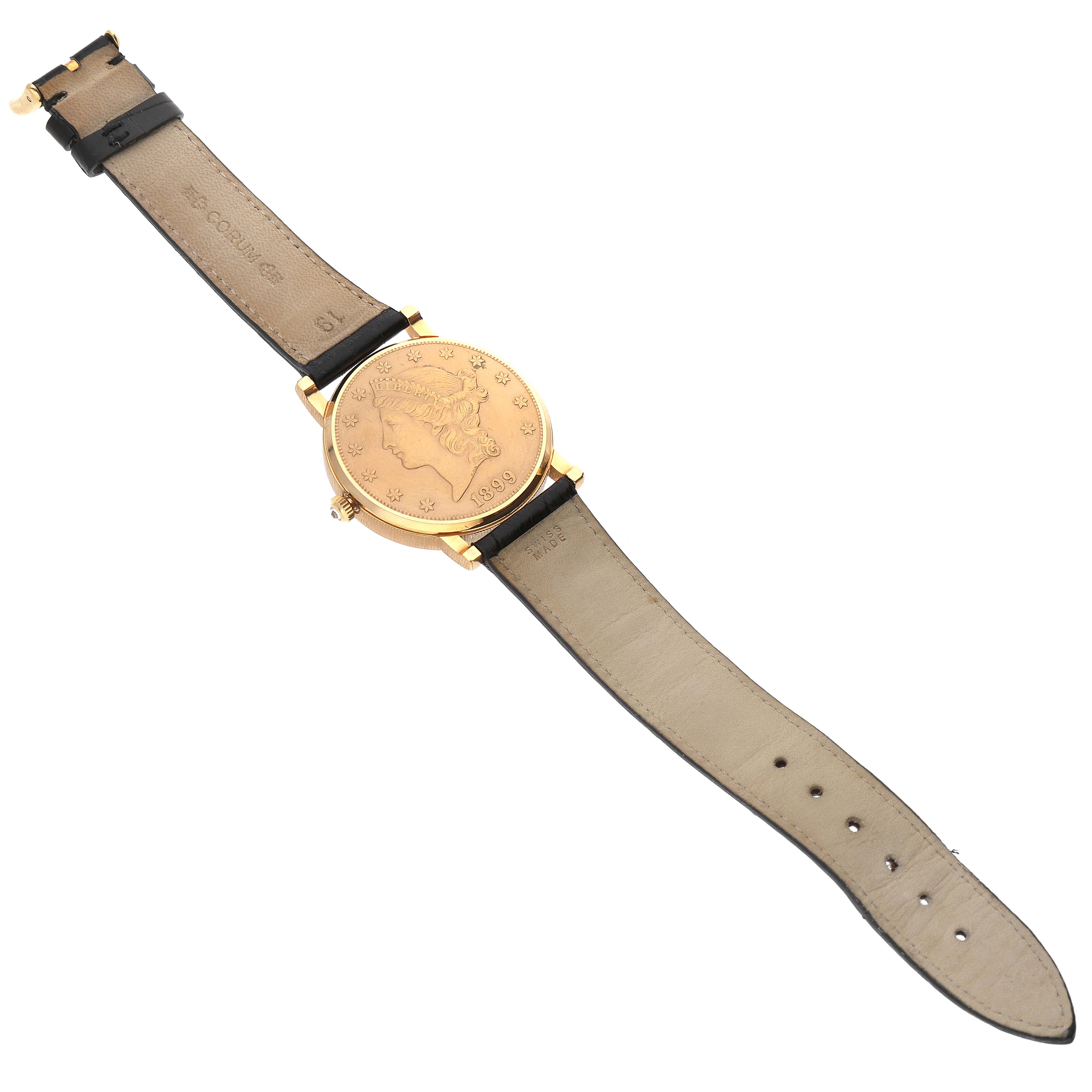 The Corum Coin Watch Men's Yellow Gold Champagne Dial Men's Yellow Gold Champagne Dial model is shown from the back, displaying the coin design and leather straps.