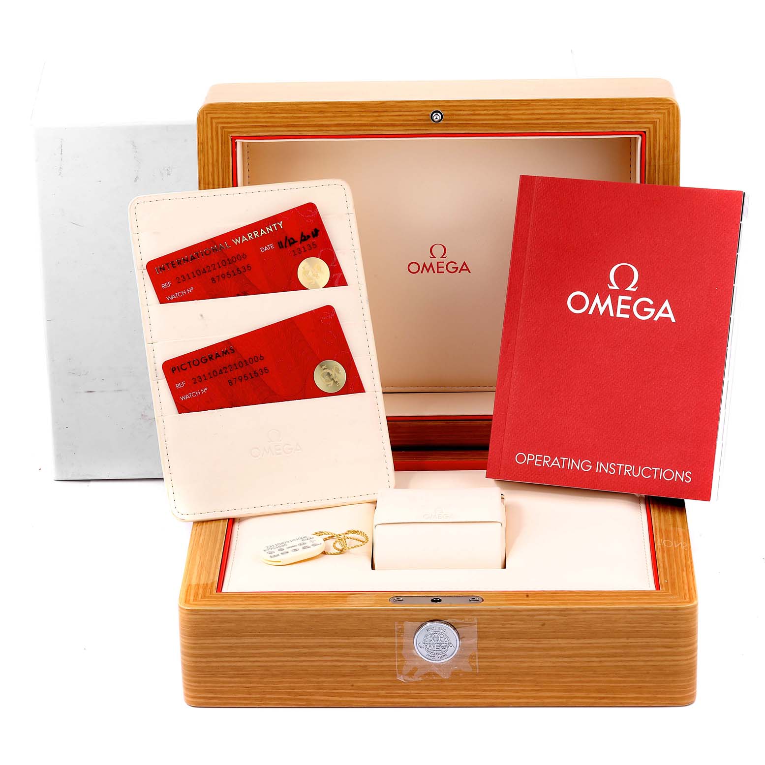 The image shows the packaging for an Omega Aqua Terra 231.10.42.21.01.006 Men
s Stainless Steel Black Dial 231.10.42.21.01.006 Men
s Stainless Steel Black Dial watch, including a wooden box, warranty cards, and an instruction manual.