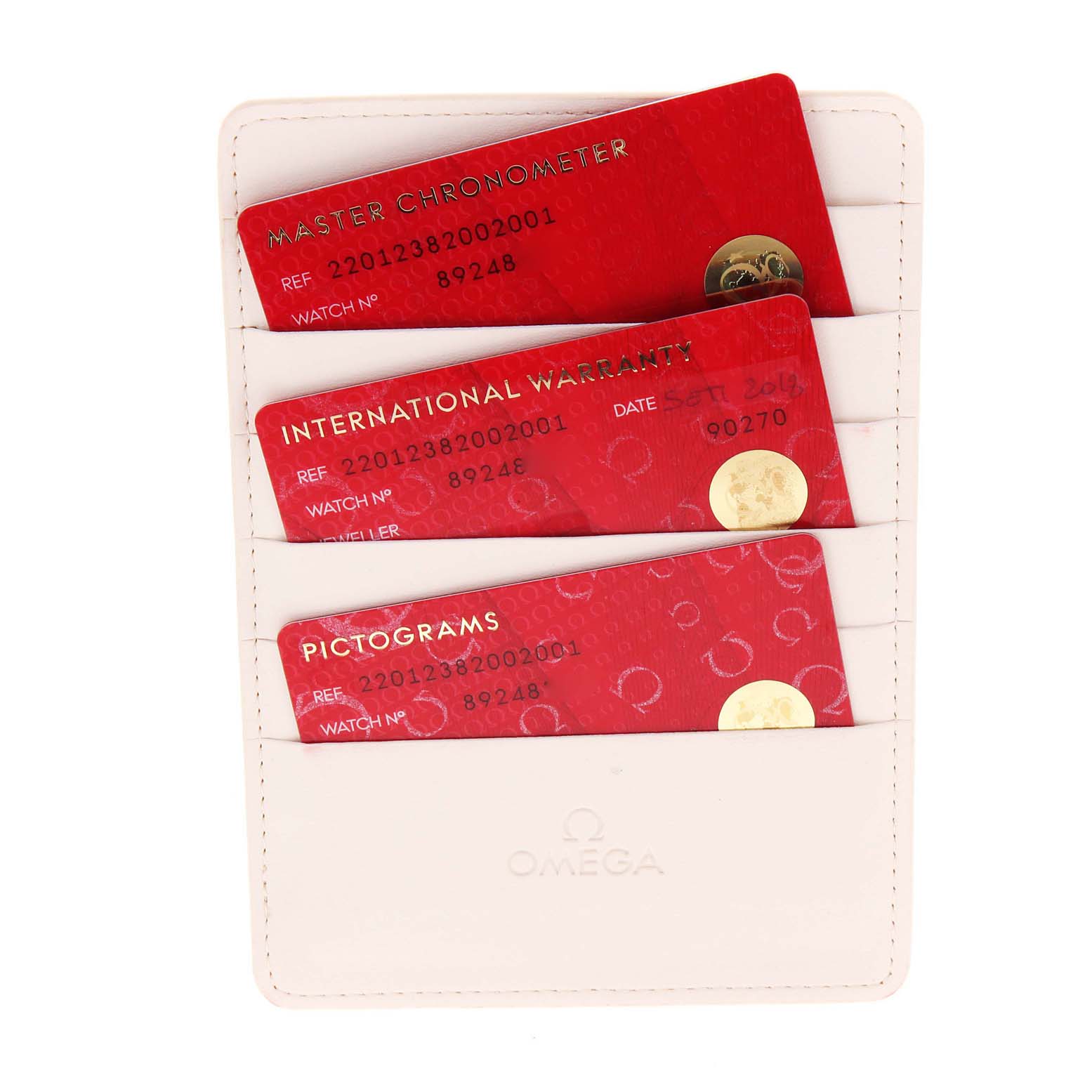 The image shows International Warranty, Master Chronometer, and Pictograms cards for an Omega Aqua Terra 220.12.38.20.02.001 Men's Stainless Steel Silver Dial 220.12.38.20.02.001 Men's Stainless Steel Silver Dial watch in a white cardholder.