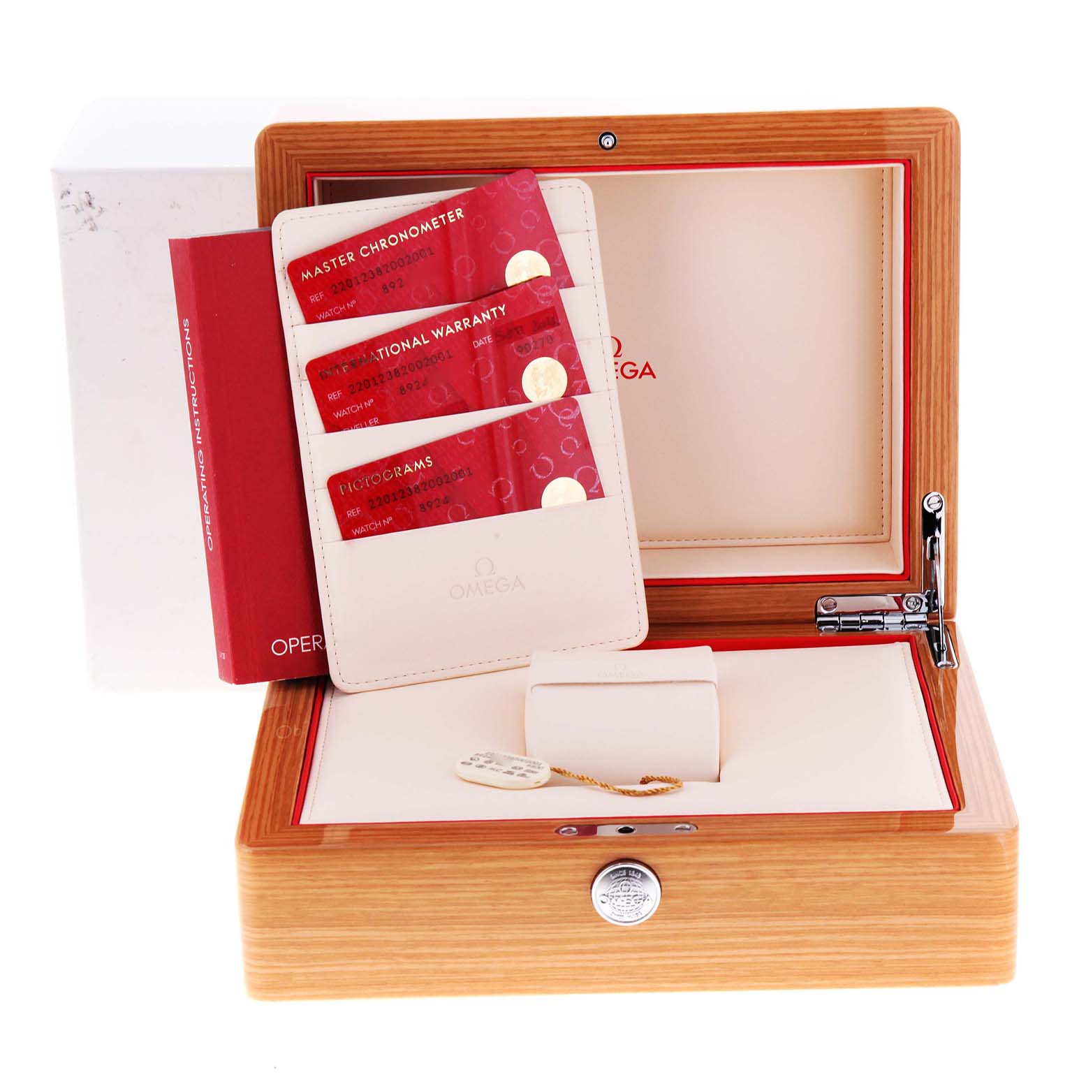 The image shows an open wooden Omega watch box for the Aqua Terra model with warranty cards and the operating instructions book.