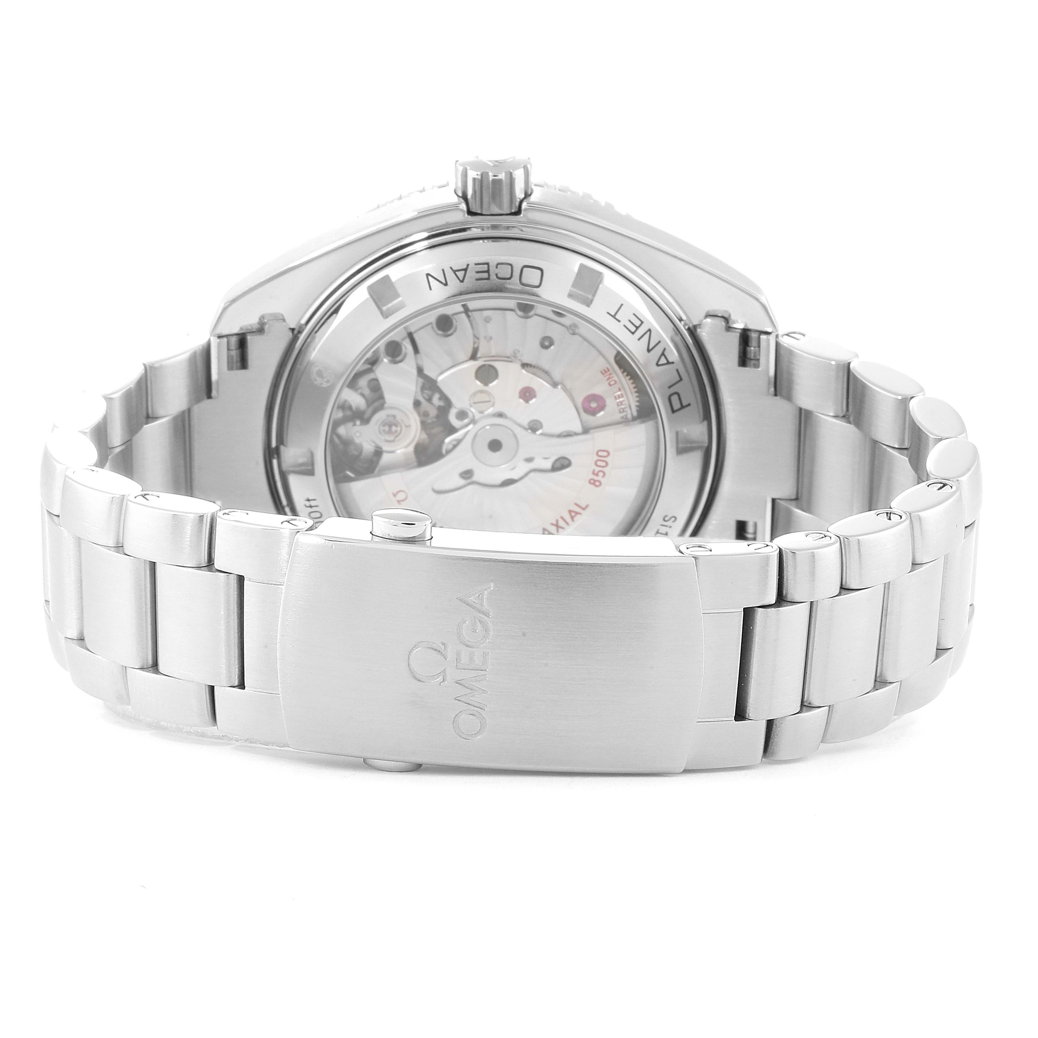 The image shows the backside of the Omega Planet Ocean 232.30.42.21.01.001 Men
s Stainless Steel Black Dial 232.30.42.21.01.001 Men
s Stainless Steel Black Dial watch, highlighting its movement through a transparent case back and the metal bracelet clasp.