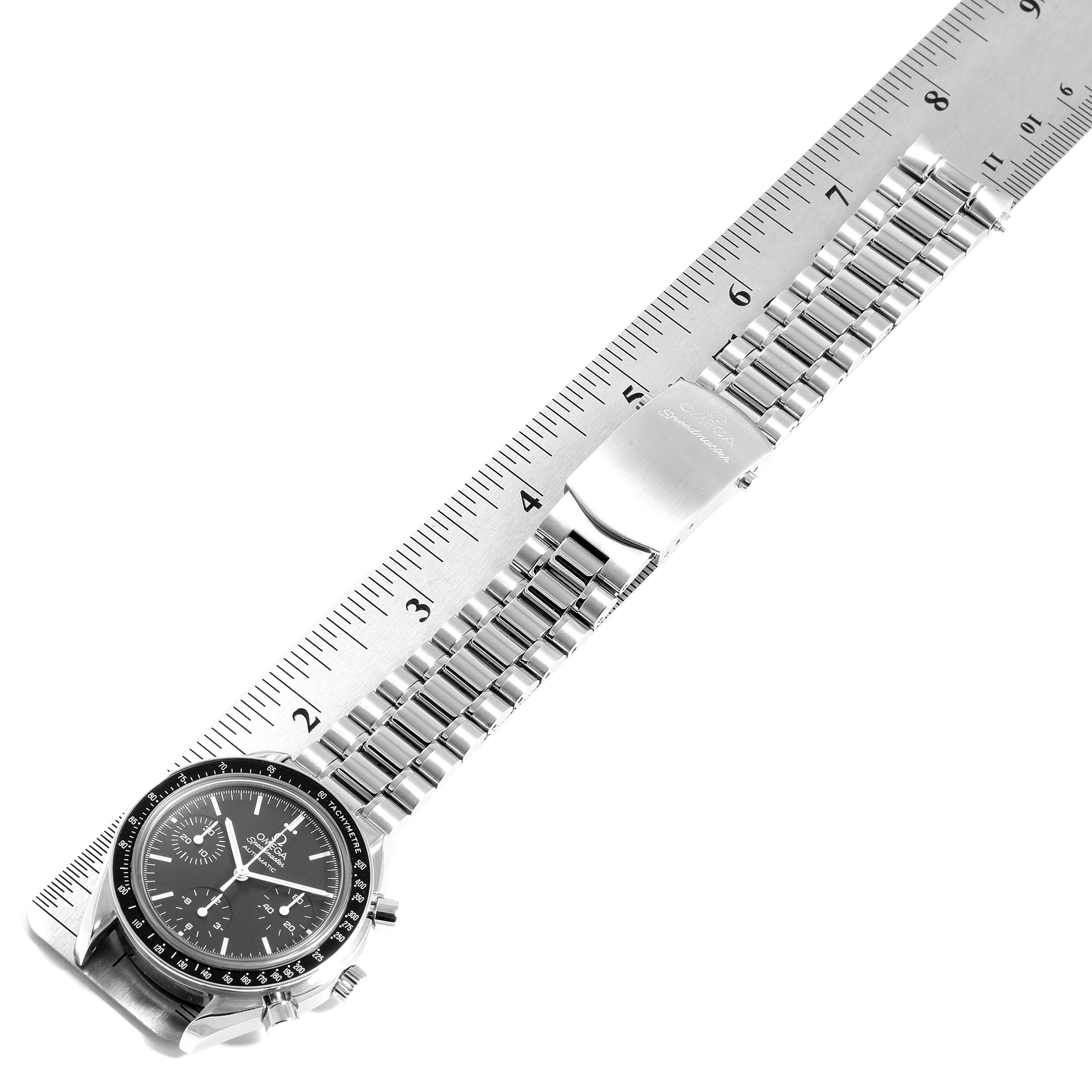 The image shows an Omega Speedmaster 3539.50.00 Men
s Stainless Steel Black Dial 3539.50.00 Men
s Stainless Steel Black Dial watch laid flat against a ruler, displaying the watch face and bracelet.