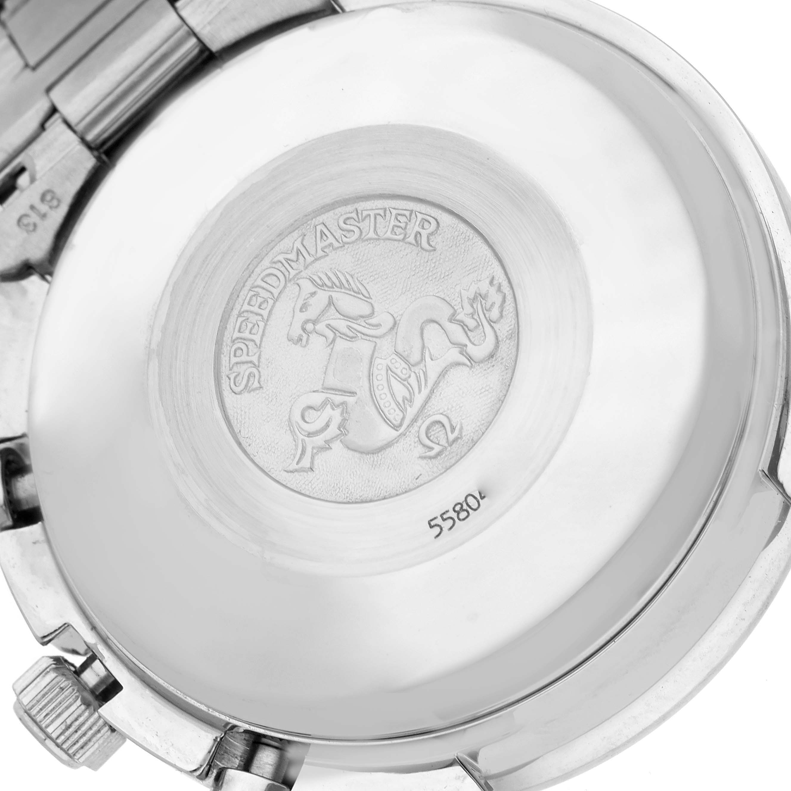 The image shows the back of an Omega Speedmaster 3521.80.00 Men
s Stainless Steel Blue Dial 3521.80.00 Men
s Stainless Steel Blue Dial watch, highlighting its engraved emblem and bracelet.