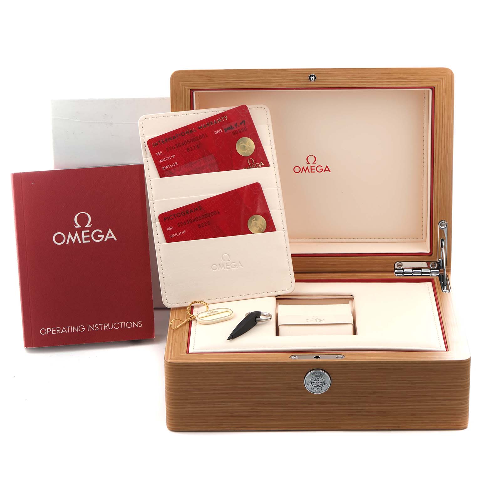 The image shows an Omega Speedmaster 326.30.40.50.02.001 Men
s Stainless Steel Silver Dial 326.30.40.50.02.001 Men
s Stainless Steel Silver Dial box with operating instructions, warranty cards, and watch accessories.