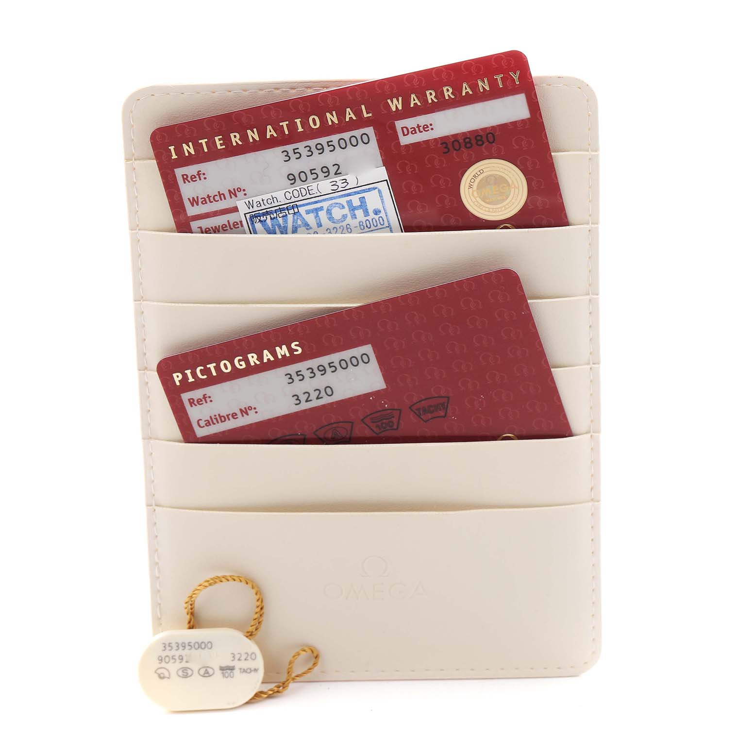 The image shows Omega Speedmaster 3539.50.00 Men
s Stainless Steel Black Dial 3539.50.00 Men
s Stainless Steel Black Dial accessories, including warranty and pictogram cards in a cream cardholder with a tag.