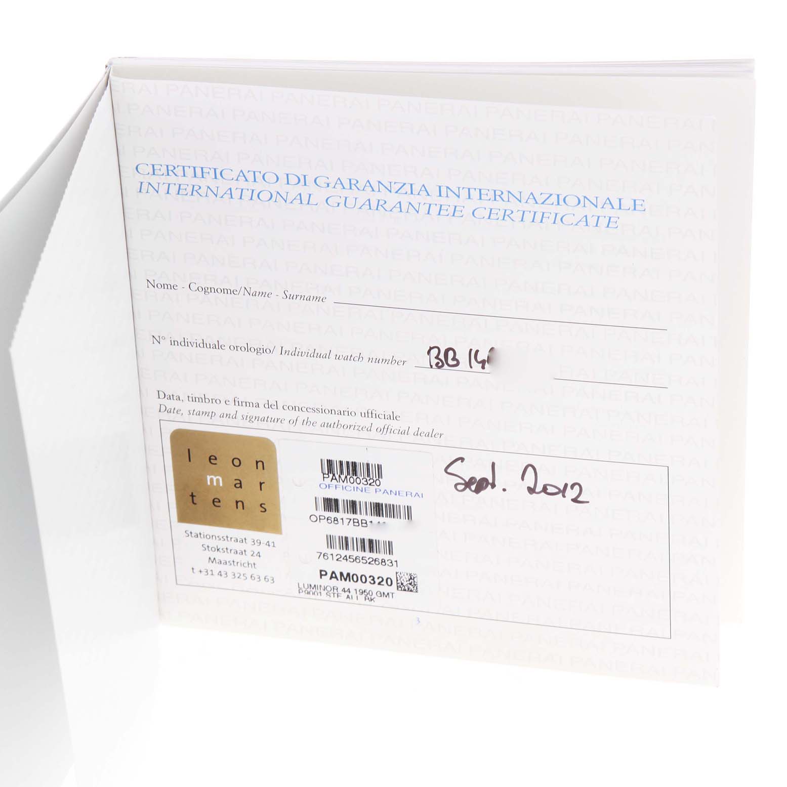 The image shows an international guarantee certificate for a Luminor model watch by Panerai, photographed at an angle revealing part of the interior.
