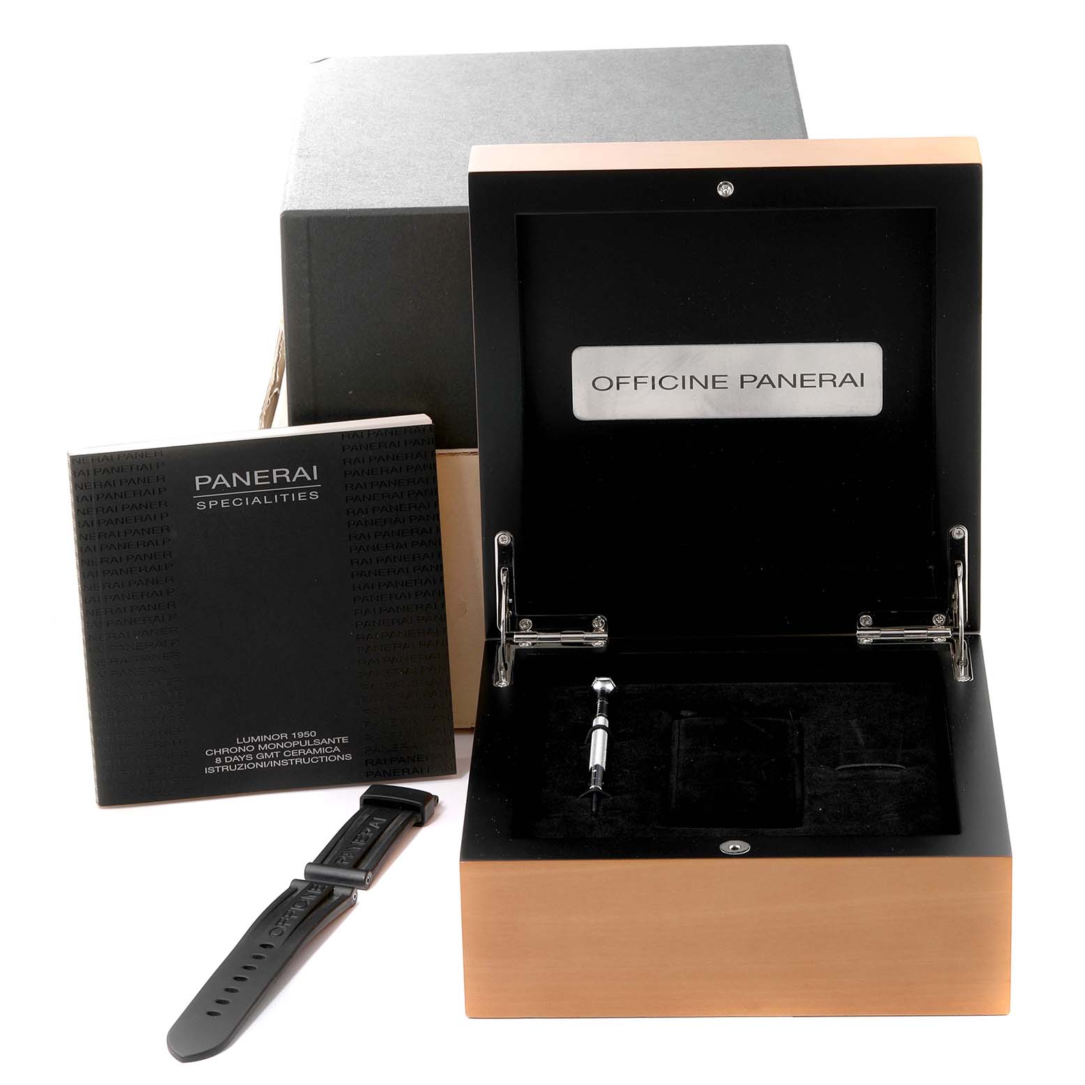 The image shows a Luminor model watch box by Panerai, an instruction manual, and an additional watch strap.