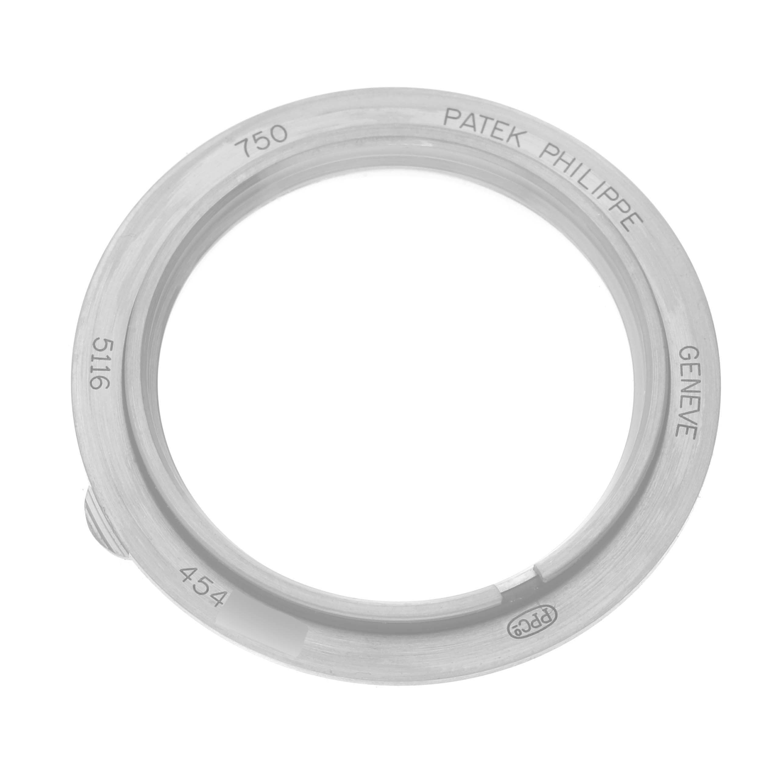 This image shows a Patek Philippe Calatrava 5116G Men
s White Gold White Dial 5116G Men
s White Gold White Dial model
s bezel from a top-down angle, displaying the engraving details prominently.