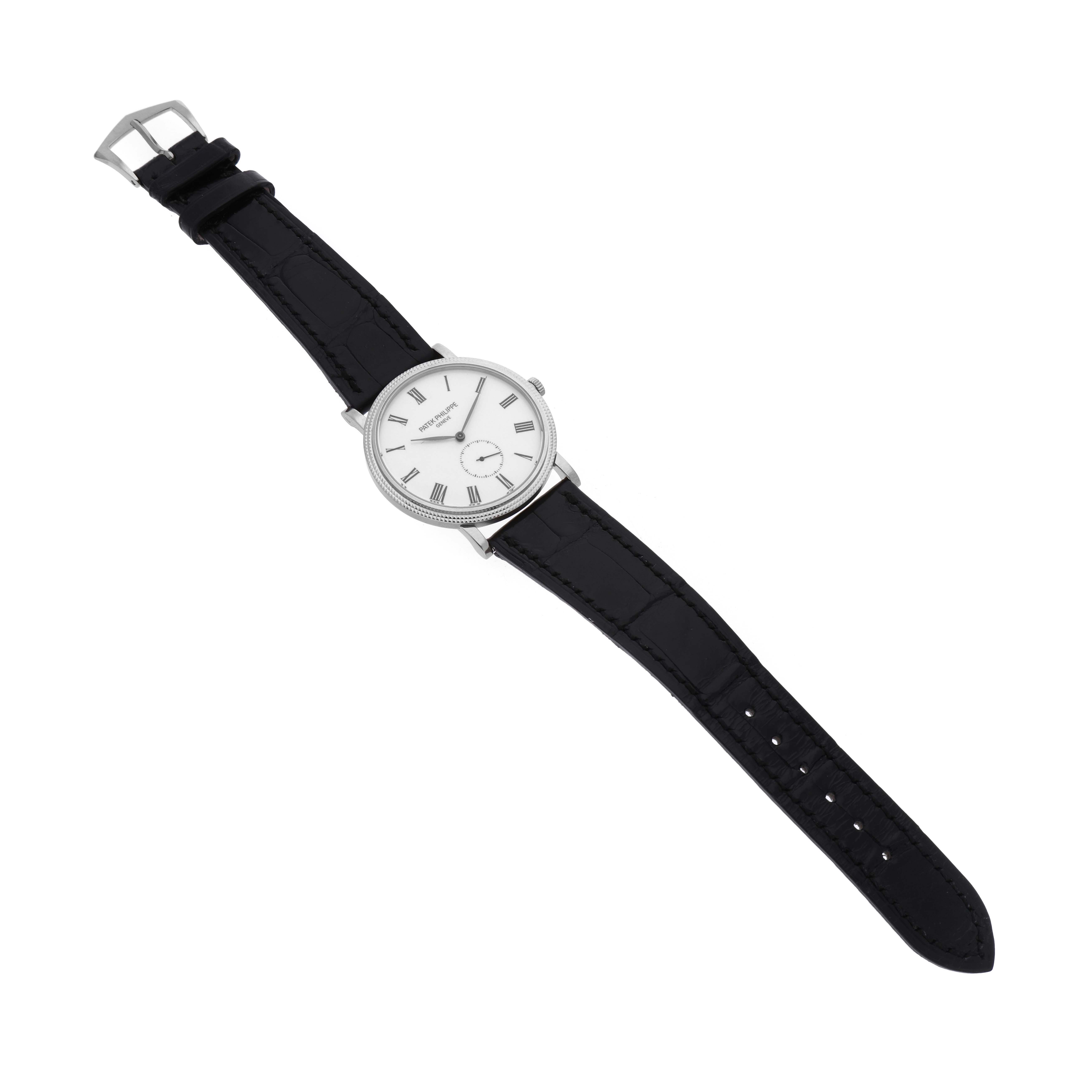 The image shows a Patek Philippe Calatrava 5116G Men
s White Gold White Dial 5116G Men
s White Gold White Dial watch, positioned diagonally, with the full strap, dial, and buckle visible.