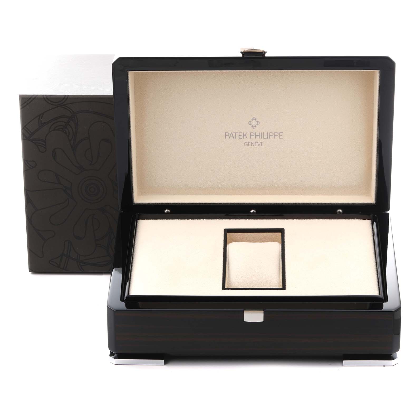 The image shows an open Patek Philippe Complications 5130G-001 Men
s White Gold Silver Dial 5130G-001 Men
s White Gold Silver Dial watch box, featuring a cream interior and black exterior.