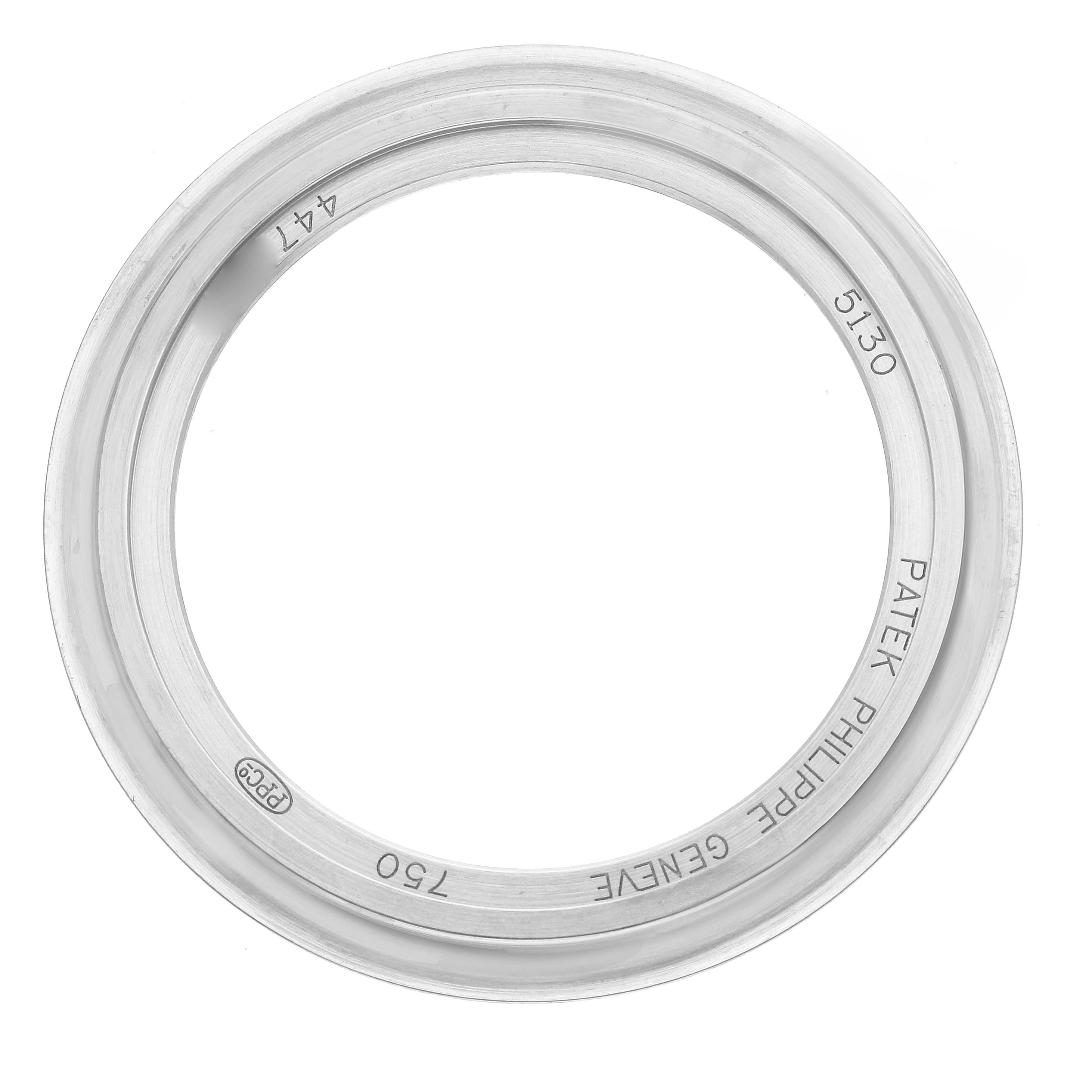 The image shows a top view of a Patek Philippe Complications 5130G-001 Men
s White Gold Silver Dial 5130G-001 Men
s White Gold Silver Dial model bezel with inscriptions and reference number 5130.