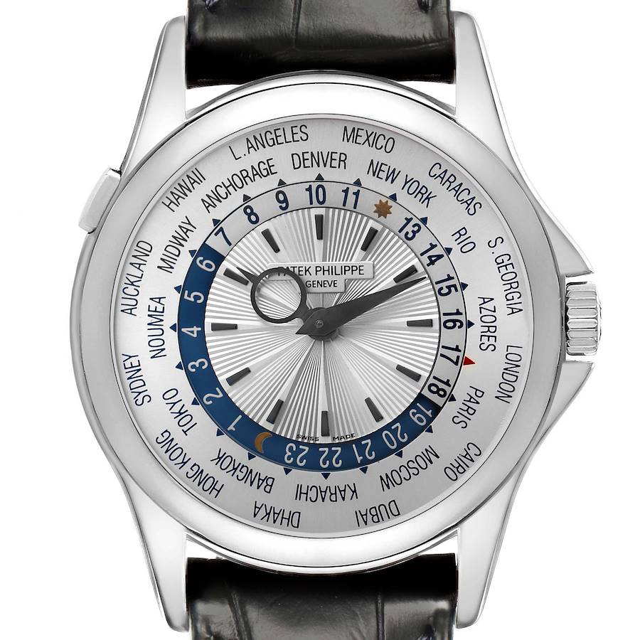 The Patek Philippe Complications watch is shown from a top-down angle, highlighting the world time dial and black leather strap.