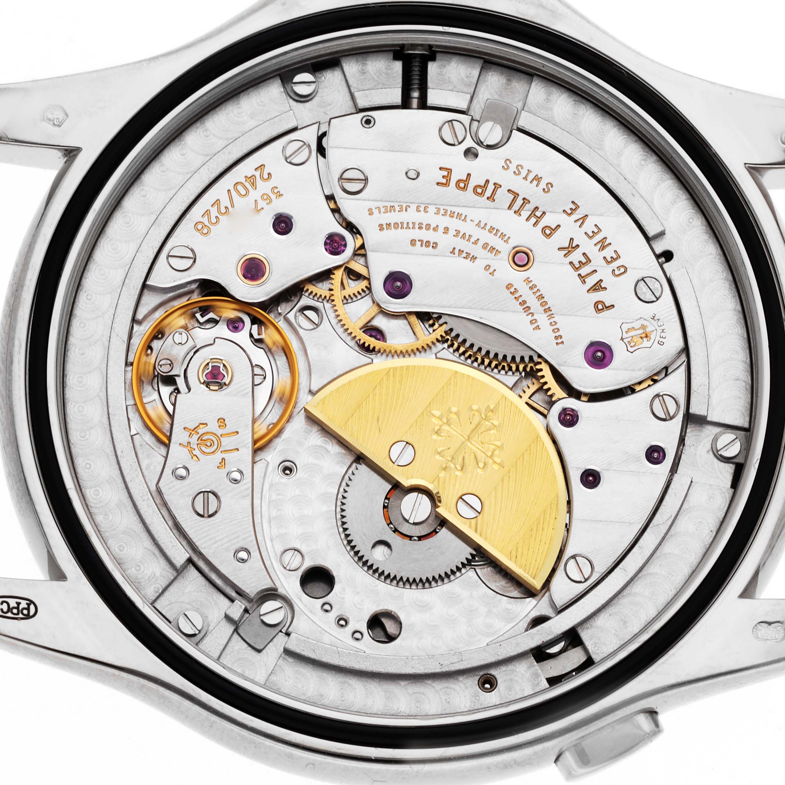 The image shows the back view of a Patek Philippe Complications 5130G-001 Men
s White Gold Silver Dial 5130G-001 Men
s White Gold Silver Dial model, revealing its intricate movement and components.
