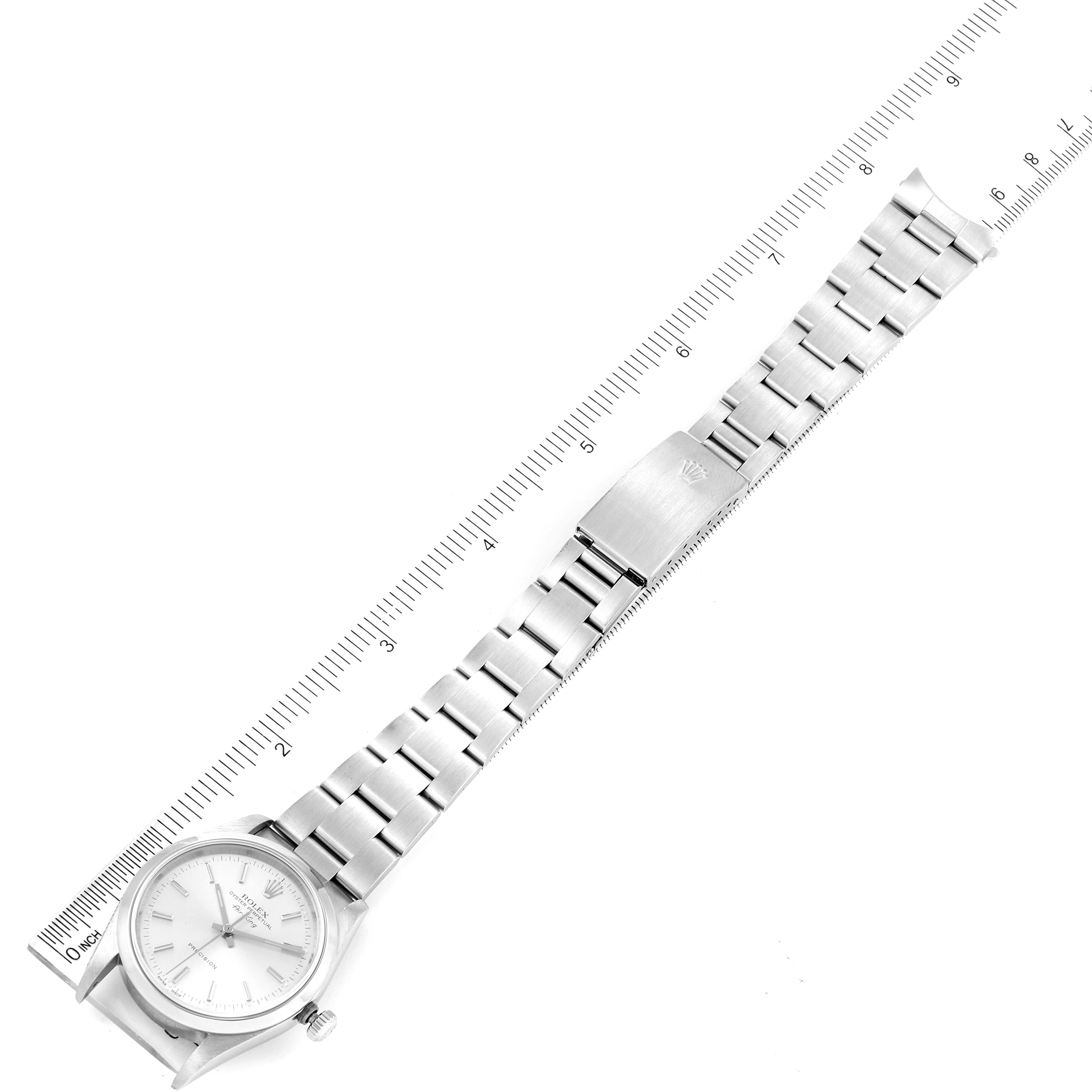 This image shows the face and full metal band of a Rolex Air-King 14000 Men's Stainless Steel Silver Dial 14000 Men's Stainless Steel Silver Dial watch, laid flat alongside a measuring scale.