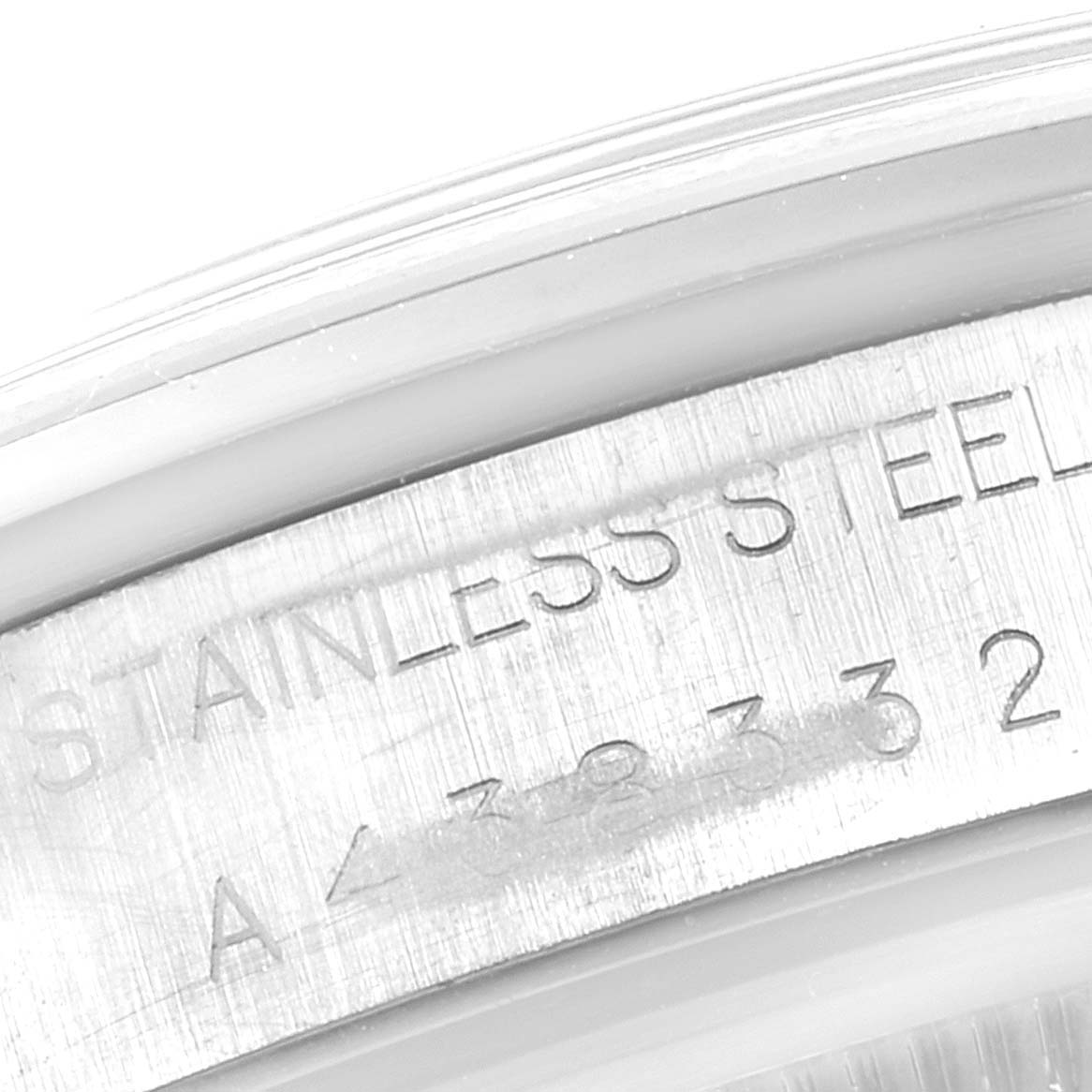 This image shows a close-up of the side of the Rolex Air-King 14000 Men's Stainless Steel White Dial 14000 Men's Stainless Steel White Dial watch case with part of its serial number and "STAINLESS STEEL" engraving visible.