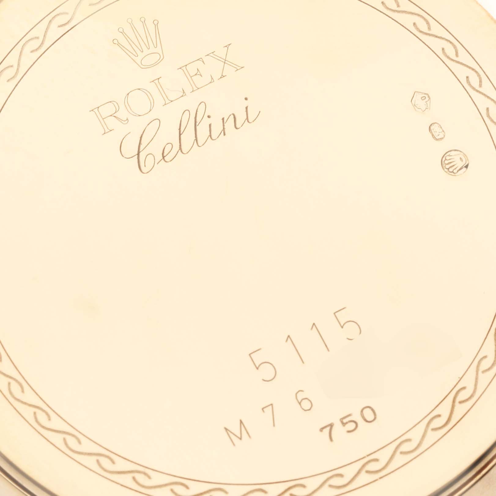 This image shows a close-up of the back case of a Rolex Cellini 5115/8 Men's Yellow Gold White Dial 5115/8 Men's Yellow Gold White Dial watch, featuring engravings and hallmarks.