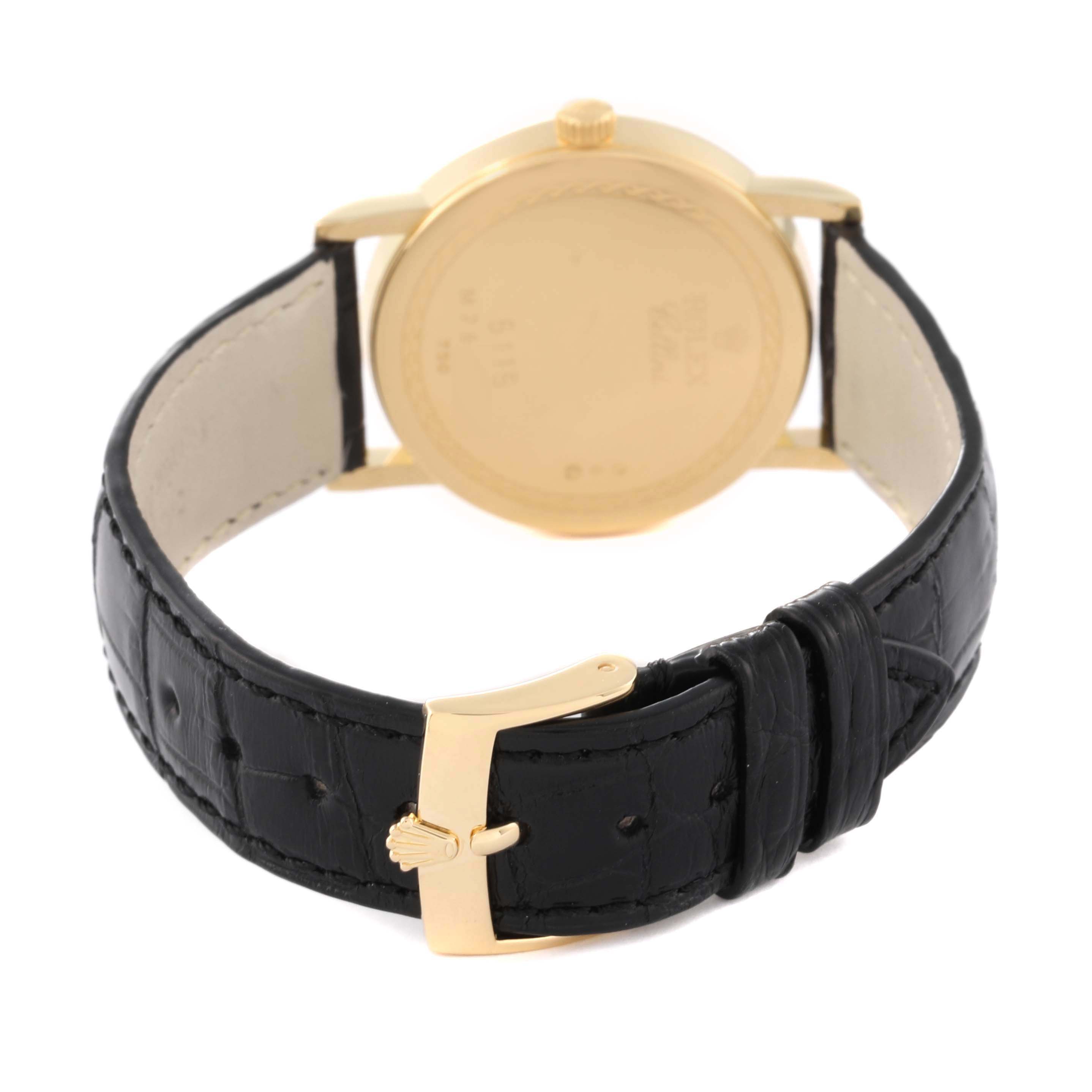 The image shows the back view of a Rolex Cellini 5115/8 Men's Yellow Gold White Dial 5115/8 Men's Yellow Gold White Dial model watch, highlighting the gold caseback and black leather strap.