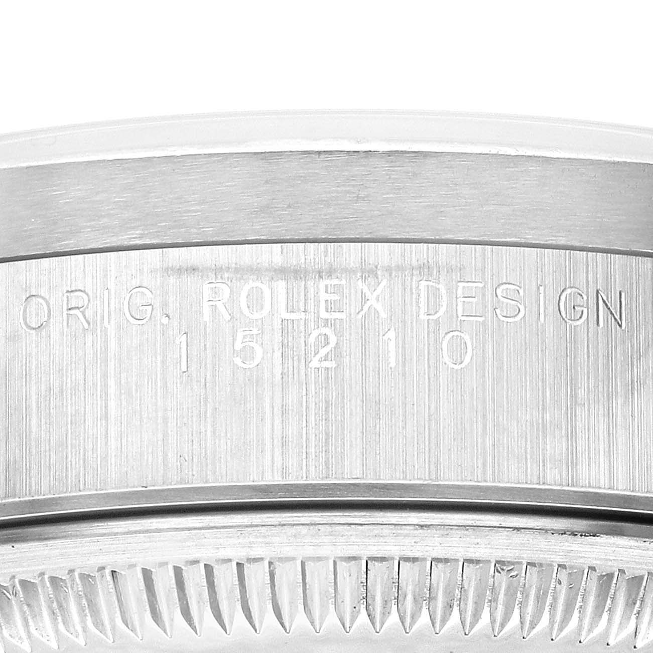 This image shows a close-up of the case back edge of a Rolex Date 15210 Men's Stainless Steel Silver Dial 15210 Men's Stainless Steel Silver Dial model, highlighting the engraving and serial number.