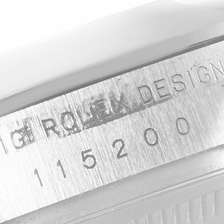 This photo shows a close-up of the serial number and "Rolex" branding on the edge of a Date model Rolex watch.