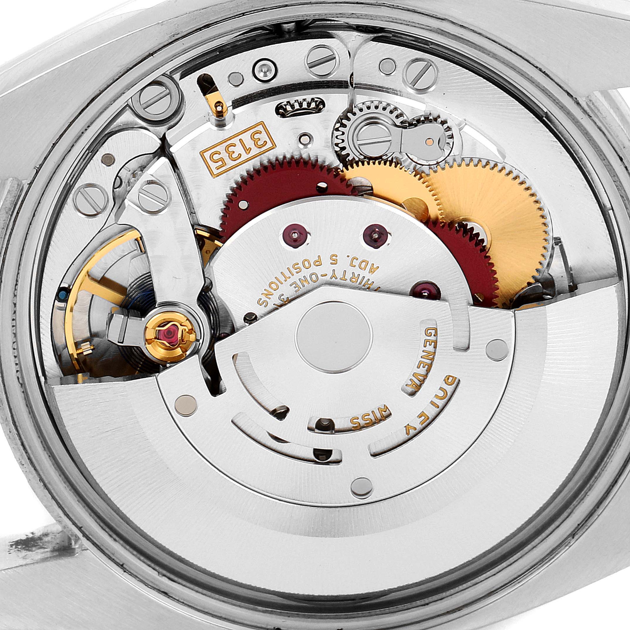 The image shows a close-up view of the movement mechanism of a Rolex Date 115200 Men's Stainless Steel Blue Dial 115200 Men's Stainless Steel Blue Dial model watch.