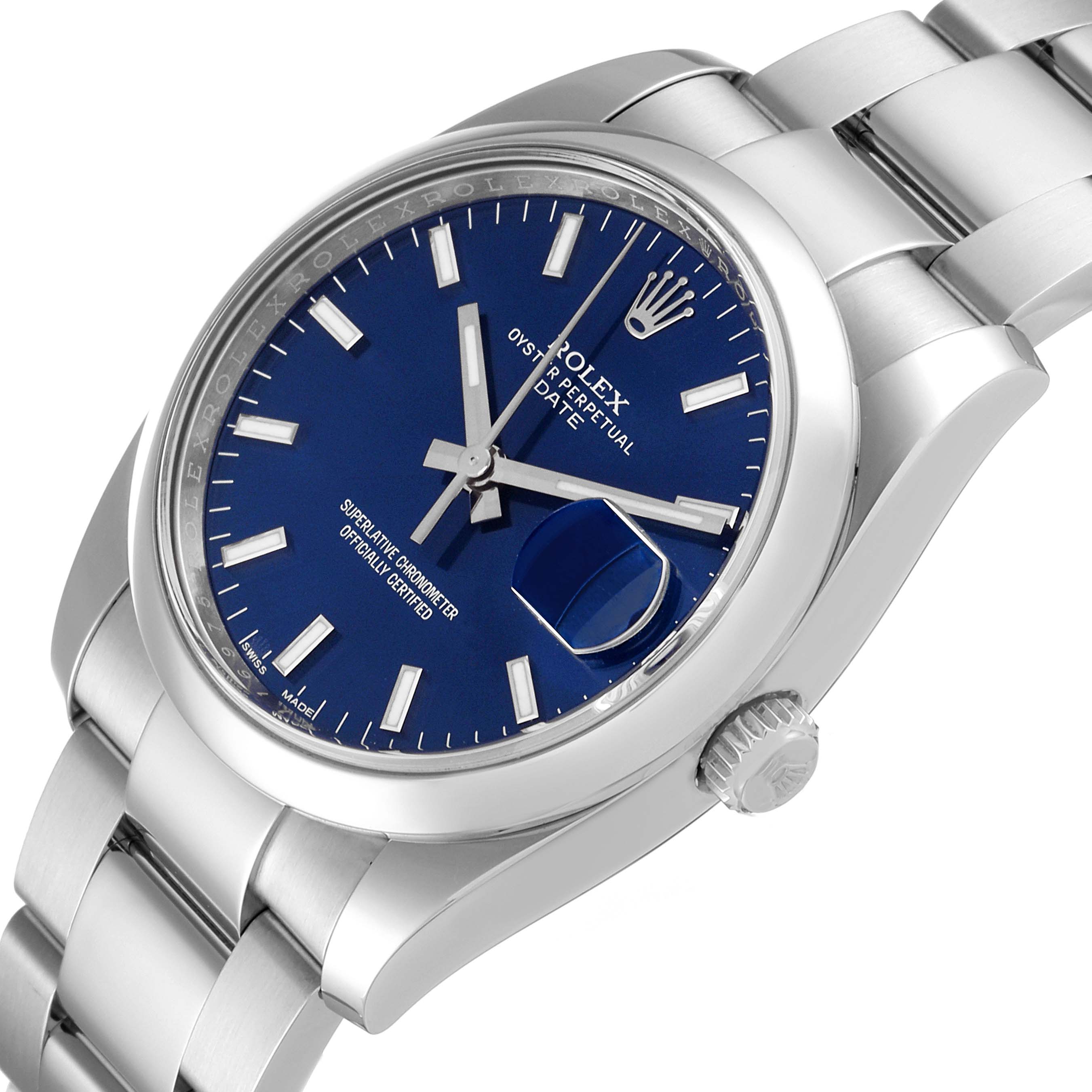 This image shows a Rolex Date 115200 Men's Stainless Steel Blue Dial 115200 Men's Stainless Steel Blue Dial model watch at a slight side angle, revealing the blue dial, crown, and bracelet.