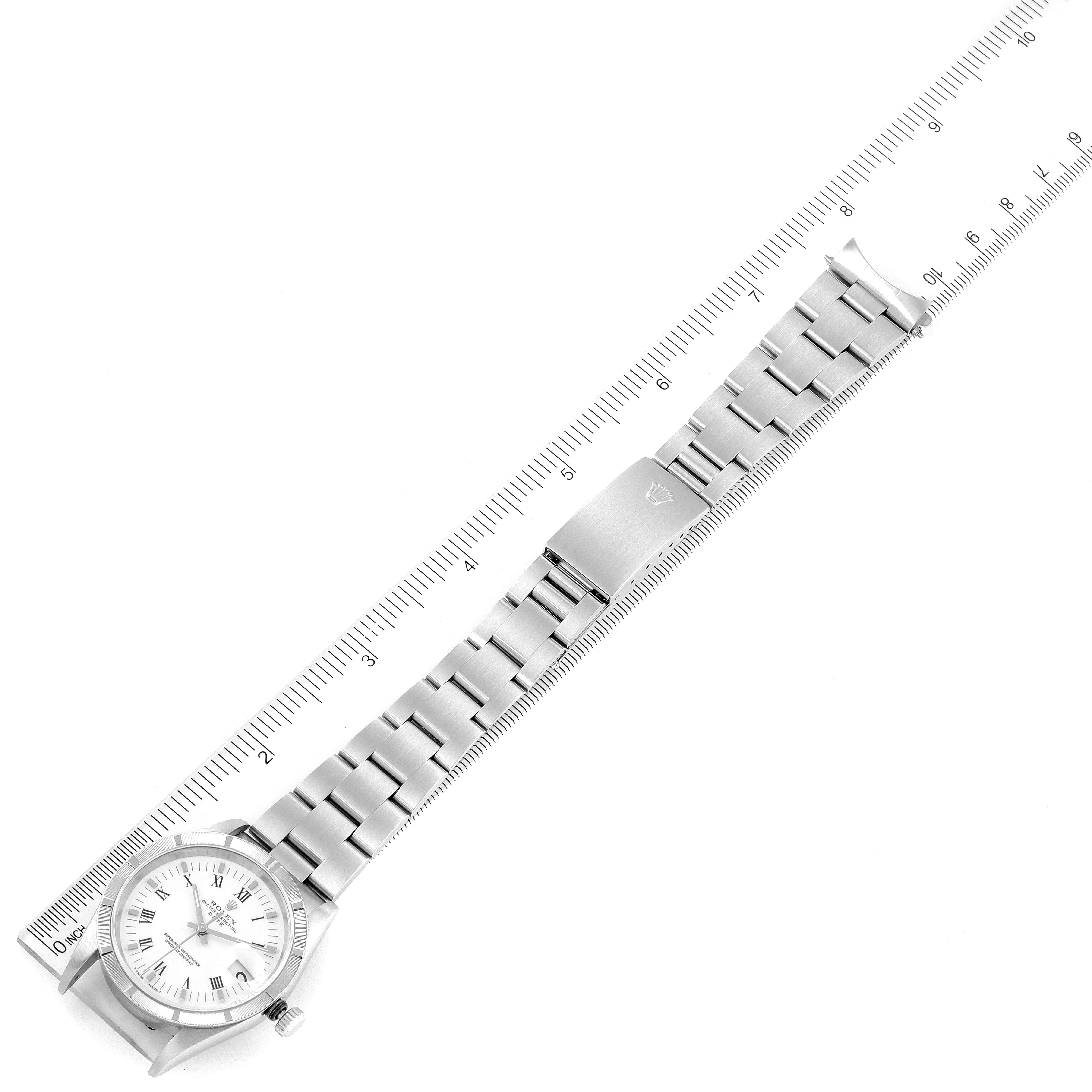 The Rolex Date 15210 Men's Stainless Steel White Dial 15210 Men's Stainless Steel White Dial model watch is shown from a top-down angle, displaying the dial, bracelet, and clasp aligned with a ruler.