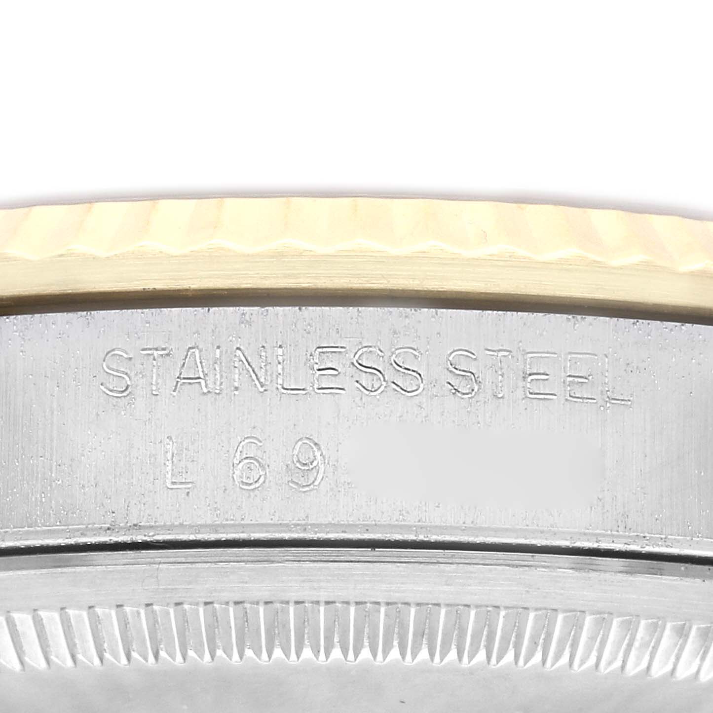 This image shows a close-up of the stainless steel case and fluted bezel of a Rolex Datejust 16233 Men's Steel and Gold (two tone) Champagne Dial 16233 Men's Steel and Gold (two tone) Champagne Dial watch.