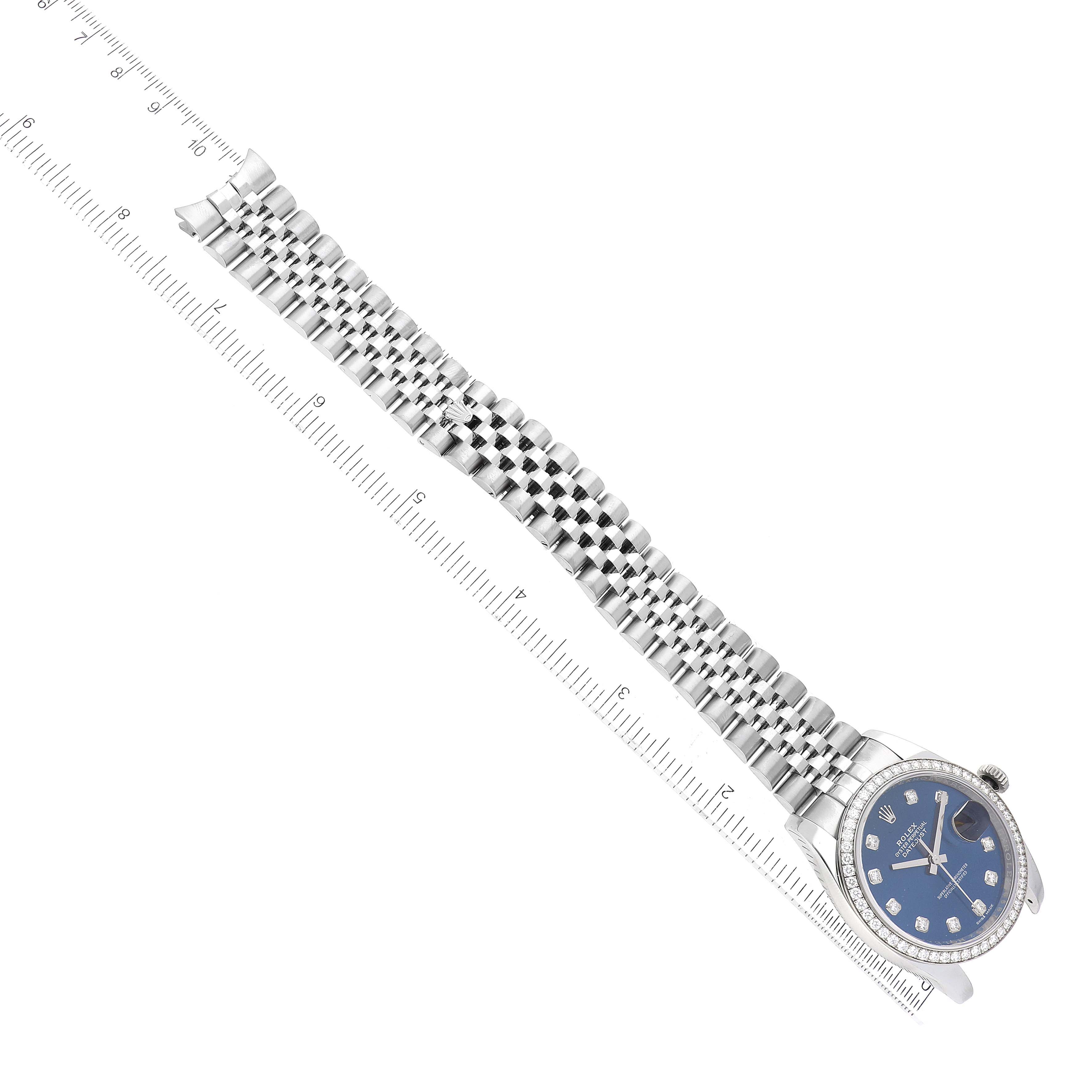 The image shows a Rolex Datejust 116244 Men's Stainless Steel Blue Dial 116244 Men's Stainless Steel Blue Dial watch laid flat with the face, bracelet, and a ruler for scale.