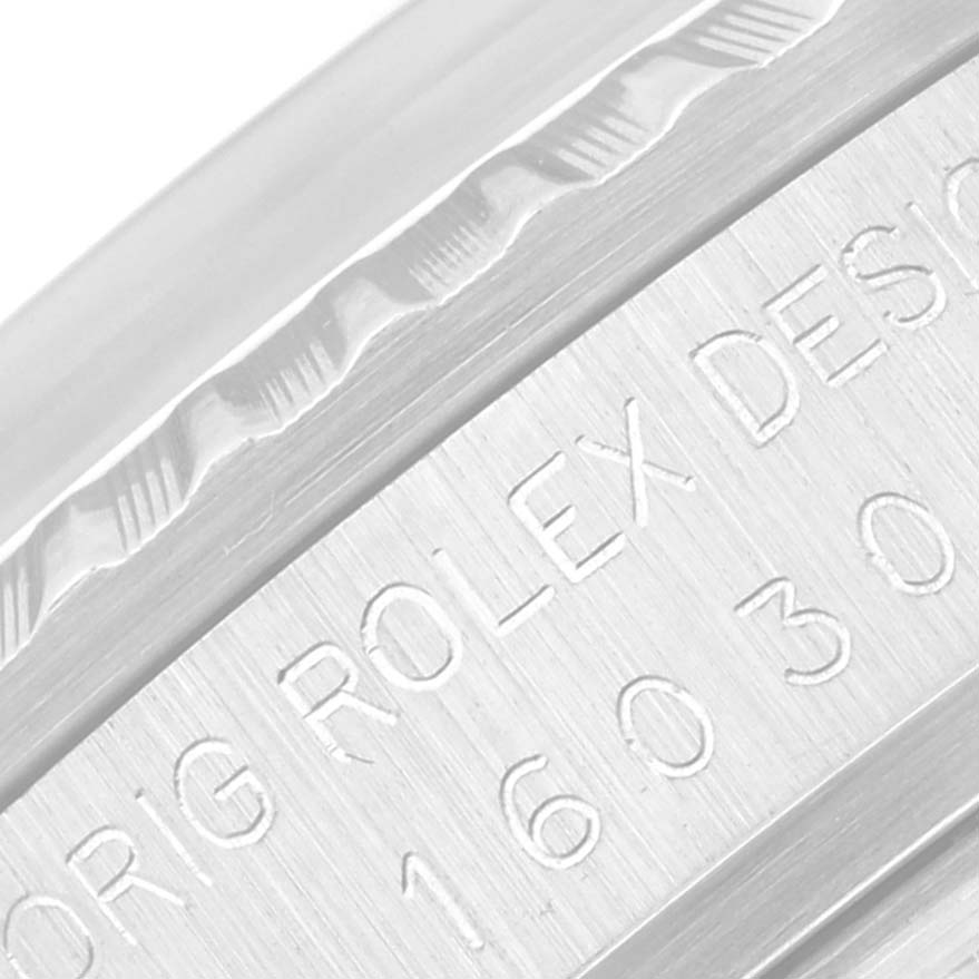 The close-up image shows the engraved bezel and case side of a Vintage Collection Rolex watch, displaying the model number and "ROLEX DESIGN."