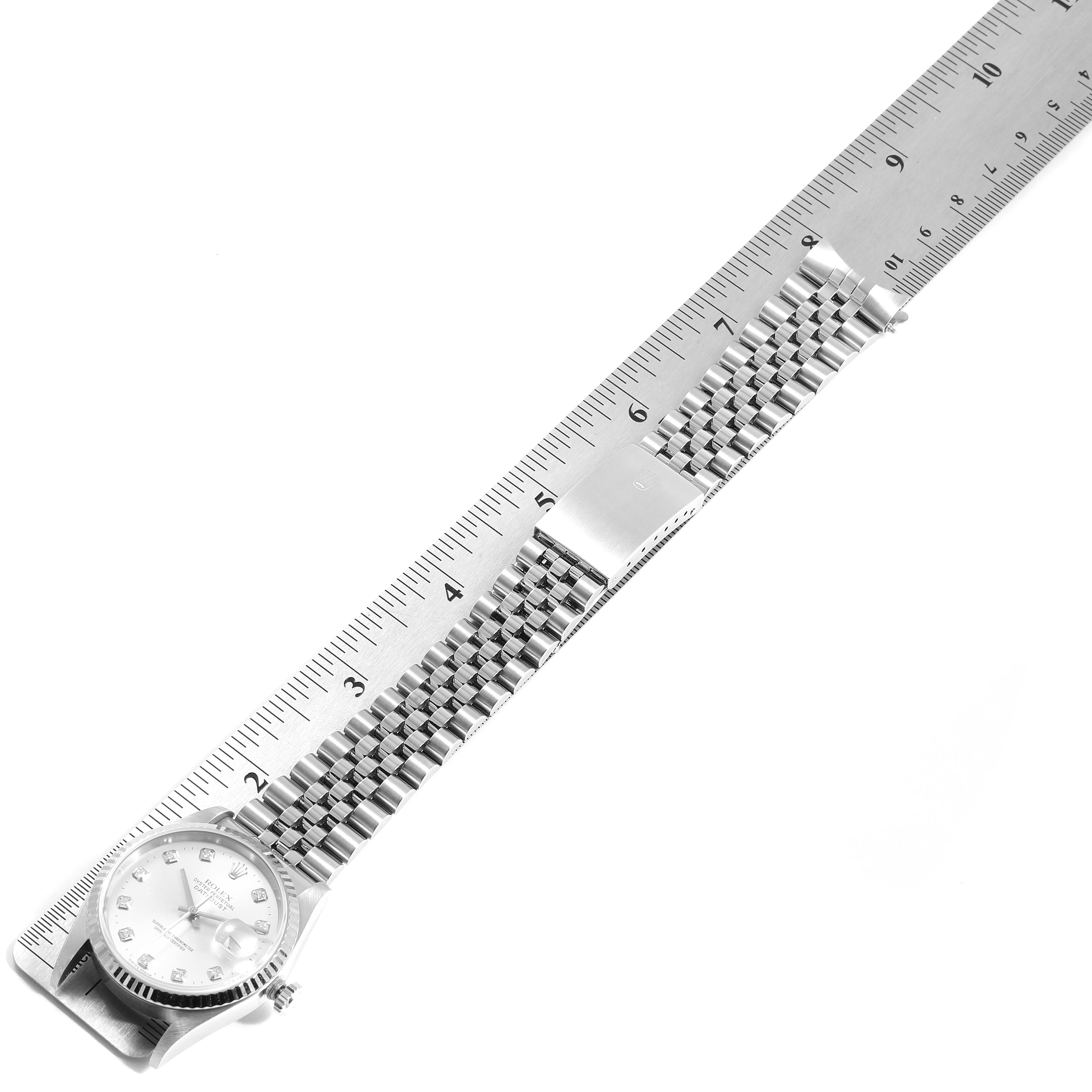 The image shows a side view of a Rolex Datejust 16234 Men's Stainless Steel Silver Dial 16234 Men's Stainless Steel Silver Dial watch with a jubilee bracelet next to a ruler for measurement.