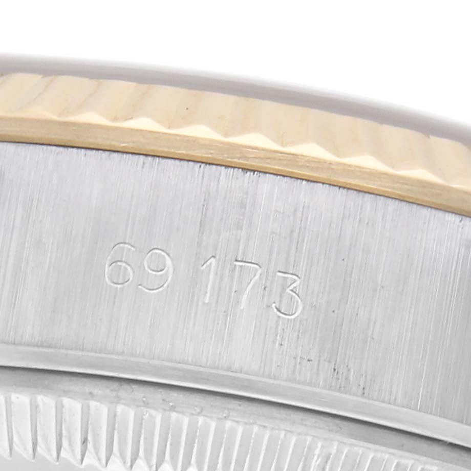 The image shows a close-up of the case edge and bezel of a Rolex Datejust 69173 Women
s Steel and Gold (two tone) Champagne Dial 69173 Women
s Steel and Gold (two tone) Champagne Dial, highlighting the serial number.