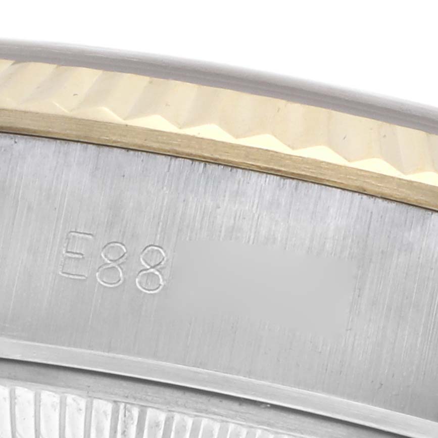 The image shows a close-up of the Rolex Datejust 69173 Women
s Steel and Gold (two tone) Champagne Dial 69173 Women
s Steel and Gold (two tone) Champagne Dial case, focusing on the edge and part of the fluted bezel.