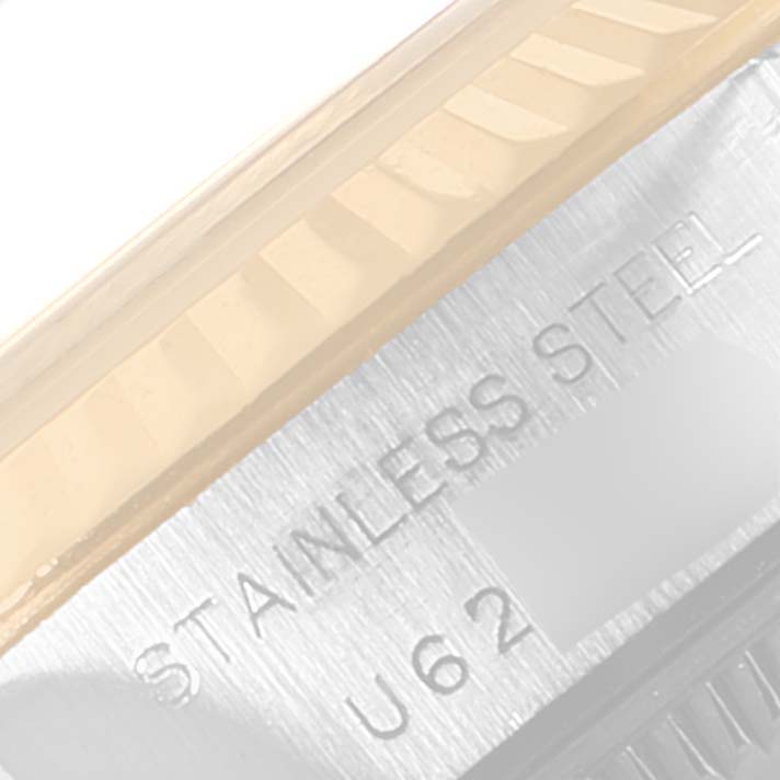 This image shows a close-up of the fluted bezel and part of the case back of a Rolex Datejust 69173 Women's Stainless Steel Black Dial 69173 Women's Stainless Steel Black Dial watch, revealing the "Stainless Steel" engraving.