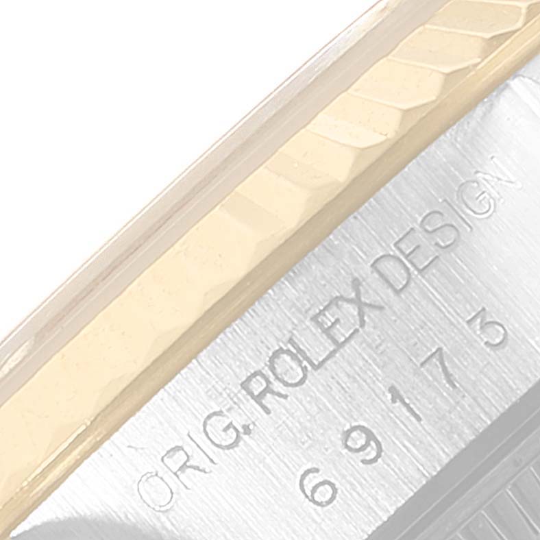 This is a close-up shot of a Rolex Datejust 69173 Women's Stainless Steel Black Dial 69173 Women's Stainless Steel Black Dial showing the case side with "ORIG. ROLEX DESIGN" and the model number engraved.