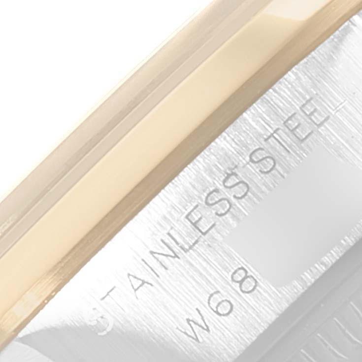 The image shows a close-up of the case of a Rolex Datejust 69163 Women's Stainless Steel Grey Dial 69163 Women's Stainless Steel Grey Dial, highlighting the word "STAINLESS STEEL."