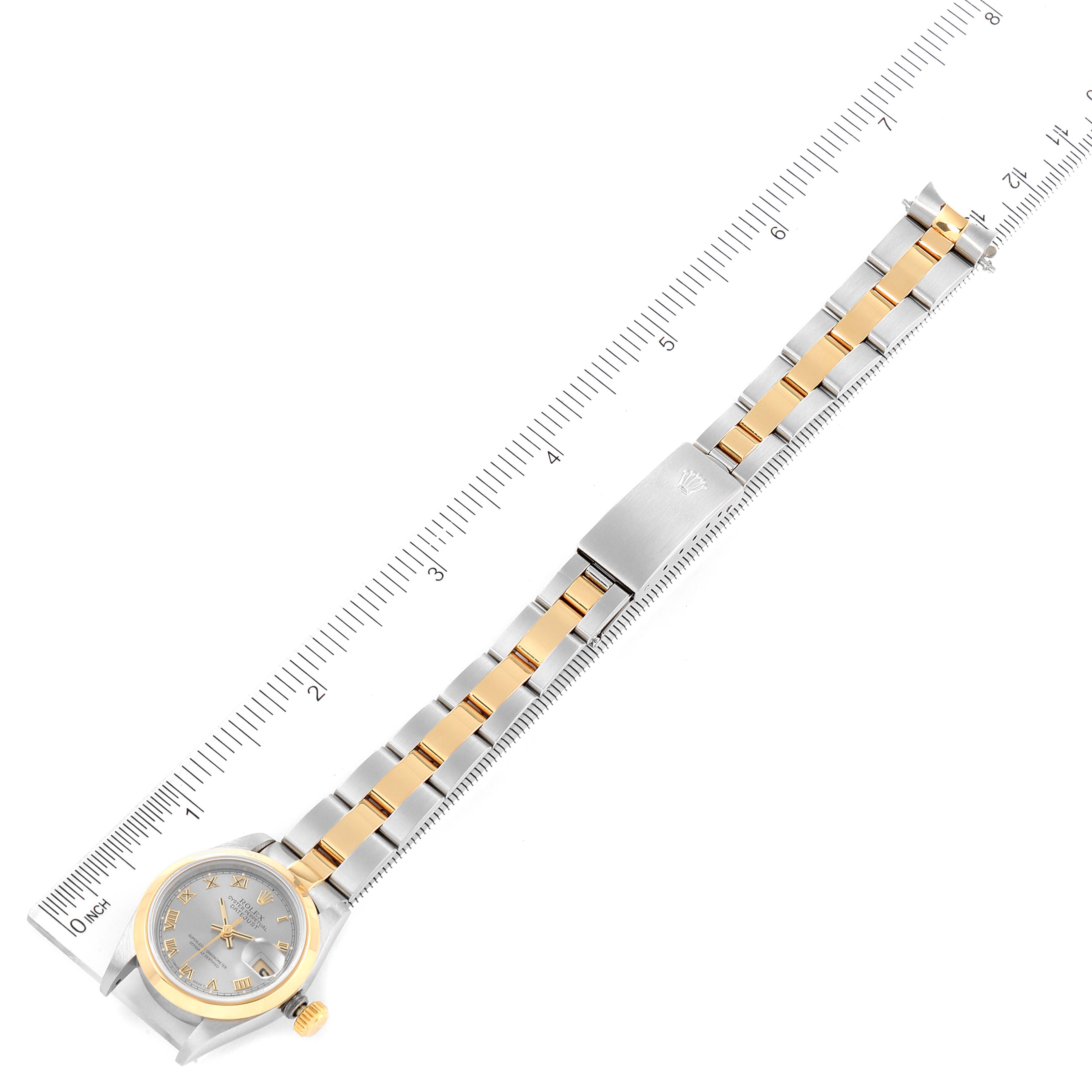 The Rolex Datejust 69163 Women's Stainless Steel Grey Dial 69163 Women's Stainless Steel Grey Dial watch is shown from a top-down angle, displaying the full bracelet, clasp, and watch face alongside a ruler for scale.