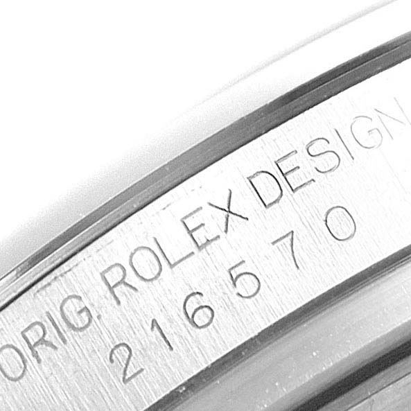 The image shows an angled close-up of the inner bezel of a Rolex Explorer 216570 Men
s Stainless Steel Black Dial 216570 Men
s Stainless Steel Black Dial watch with engraved design details and model number.