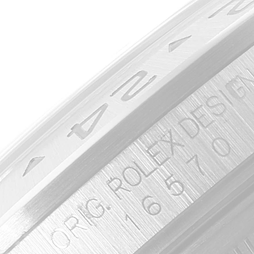The image shows a close-up view of the bezel and case edge of a Rolex Explorer 16570 Men
s Stainless Steel Black Dial 16570 Men
s Stainless Steel Black Dial watch, displaying engraved numbers and text.