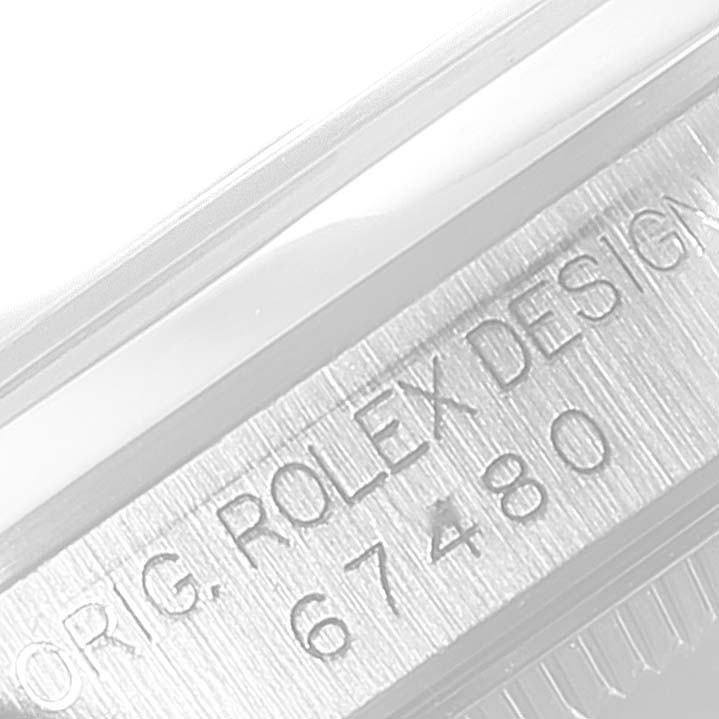 This image shows the serial number and part of the case of a Rolex Mid-Size 67480 Women
s Stainless Steel Pink Dial 67480 Women
s Stainless Steel Pink Dial watch, viewed from a close-up angle.