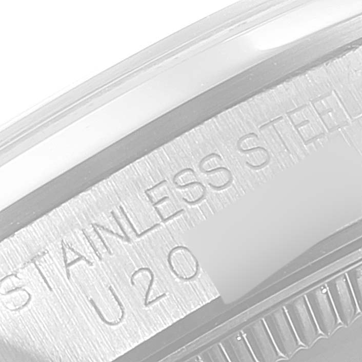 The image shows a close-up of the case back of a Rolex Mid-Size 67480 Women
s Stainless Steel Pink Dial 67480 Women
s Stainless Steel Pink Dial watch, highlighting the "STAINLESS STEEL" engraving.