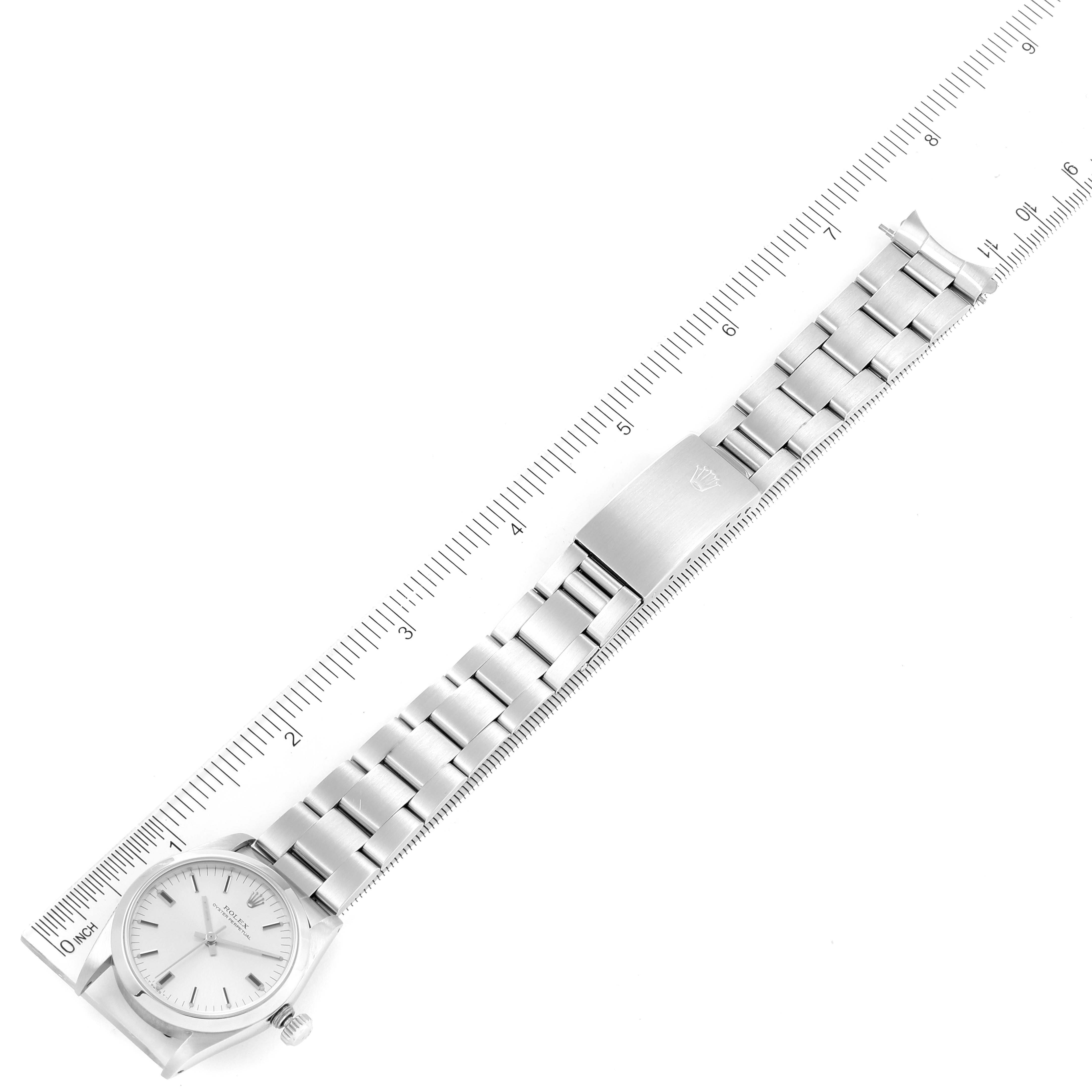 The image shows a Rolex Mid-Size 67480 Women's Stainless Steel Silver Dial 67480 Women's Stainless Steel Silver Dial model watch laid flat with a ruler measuring its length.