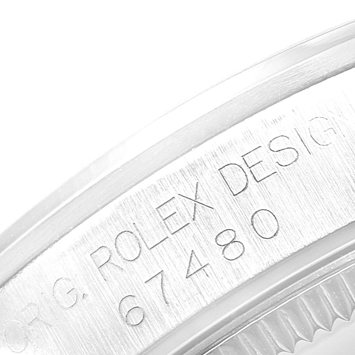 The image shows a close-up of the side of a Rolex Mid-Size 67480 Women's Stainless Steel Silver Dial 67480 Women's Stainless Steel Silver Dial watch, focusing on the model number 67480 engraving.