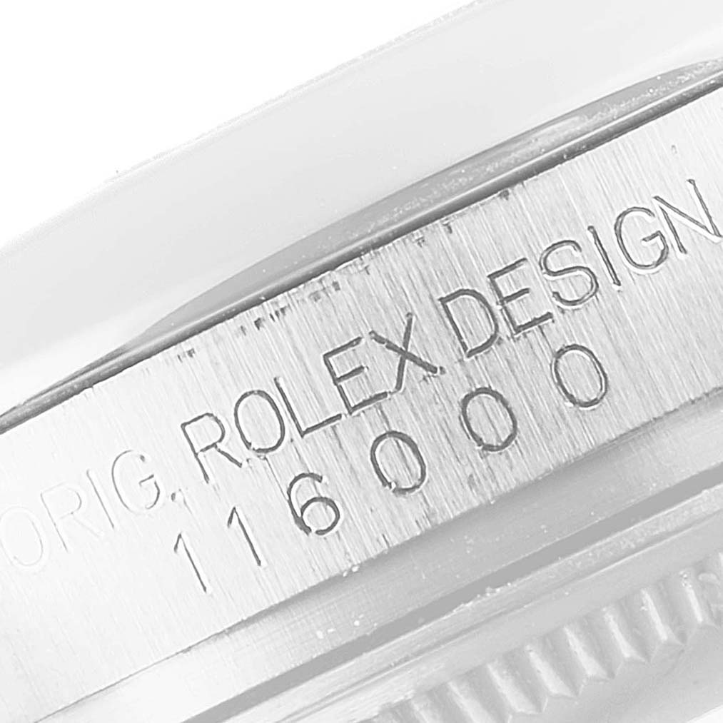 This image shows a close-up of the engraving on the casing of a Rolex Oyster Perpetual 116000 Men's Stainless Steel Blue Dial 116000 Men's Stainless Steel Blue Dial watch model 116000.