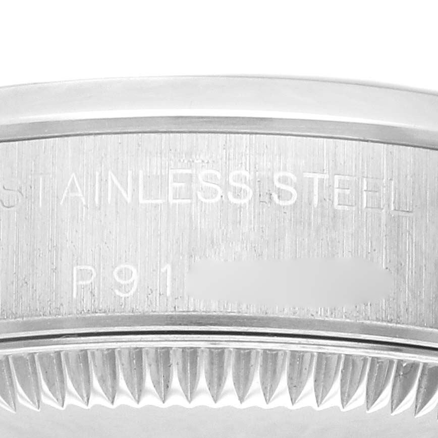 The image shows the side view of a Rolex Oyster Perpetual 76080 Women
s Stainless Steel Black Dial 76080 Women
s Stainless Steel Black Dial, focusing on the stainless steel case and serrated bezel.