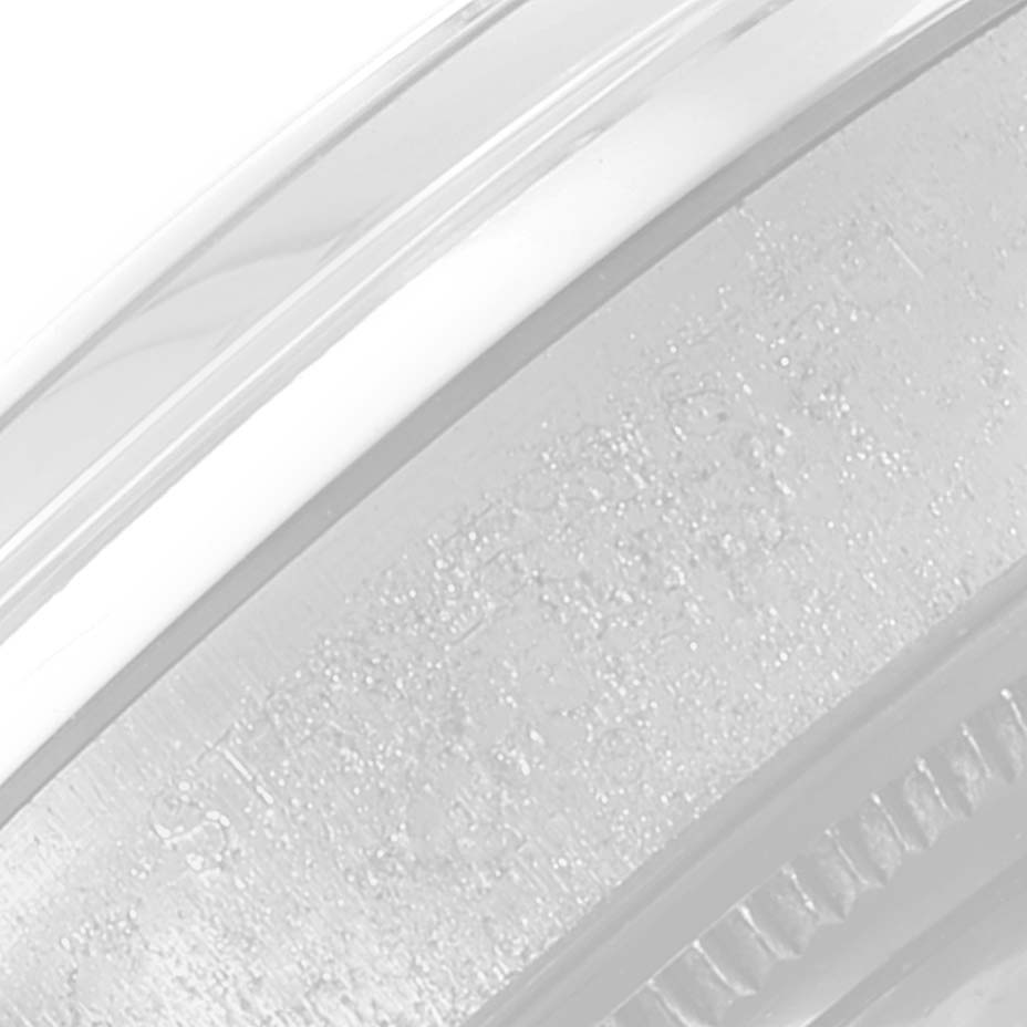 The image shows a close-up view of the rim and engravings on the case of a Rolex Date 6694 Men's Stainless Steel Black Dial 6694 Men's Stainless Steel Black Dial model watch.