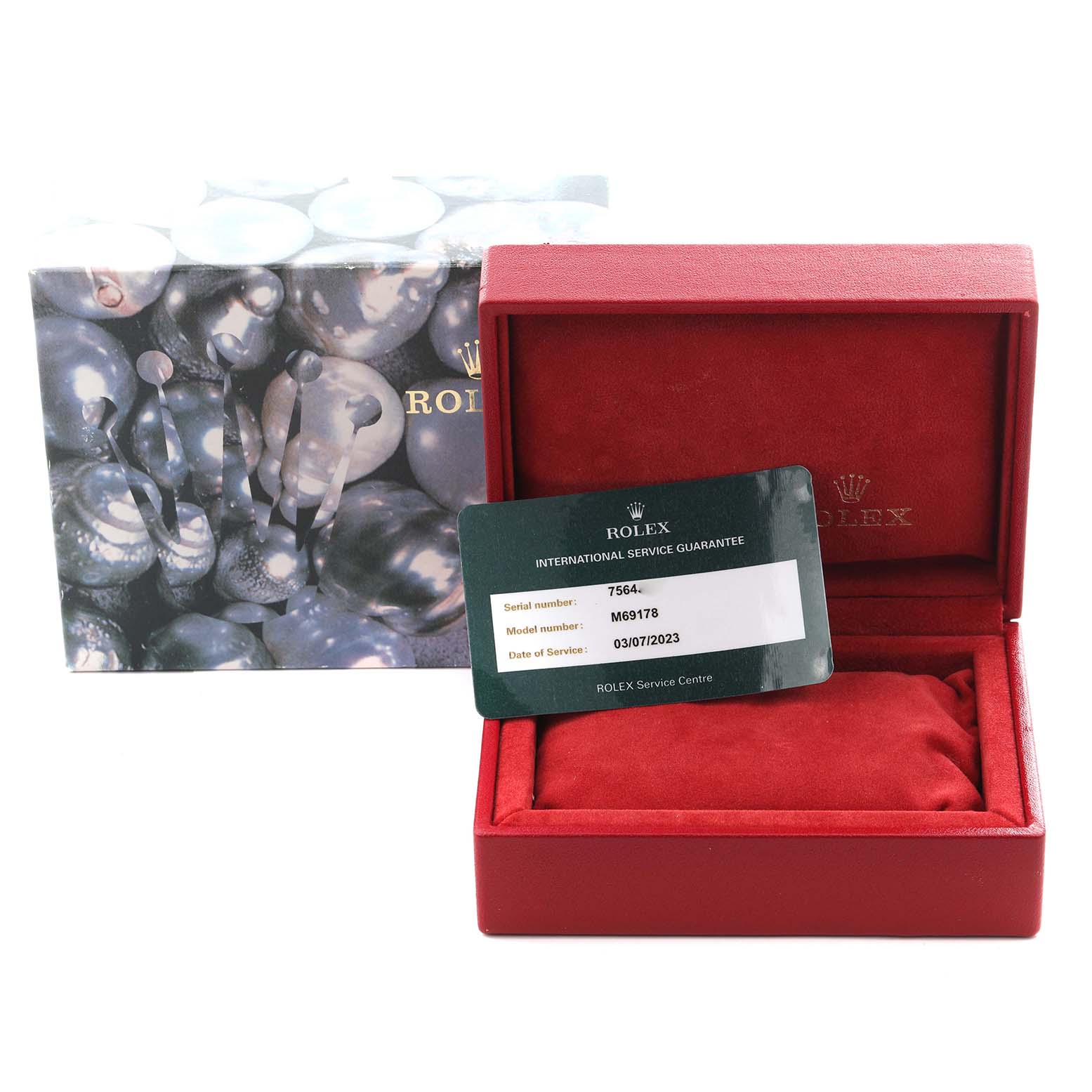 The image shows a Rolex President 69178 Women
s Yellow Gold Blue Dial 69178 Women
s Yellow Gold Blue Dial model box from an angled top view, with a service guarantee card and the original packaging.