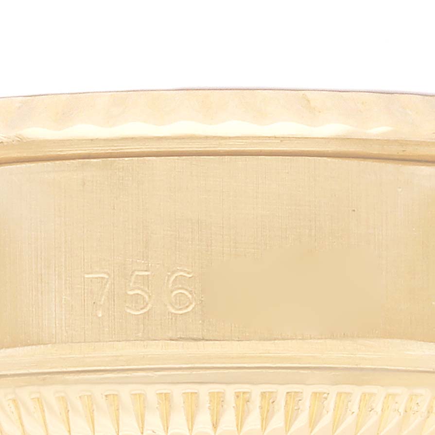 This image shows a close-up of the casing edge of a Rolex President 69178 Women
s Yellow Gold Blue Dial 69178 Women
s Yellow Gold Blue Dial model, highlighting the texture and partial engraved numbers.