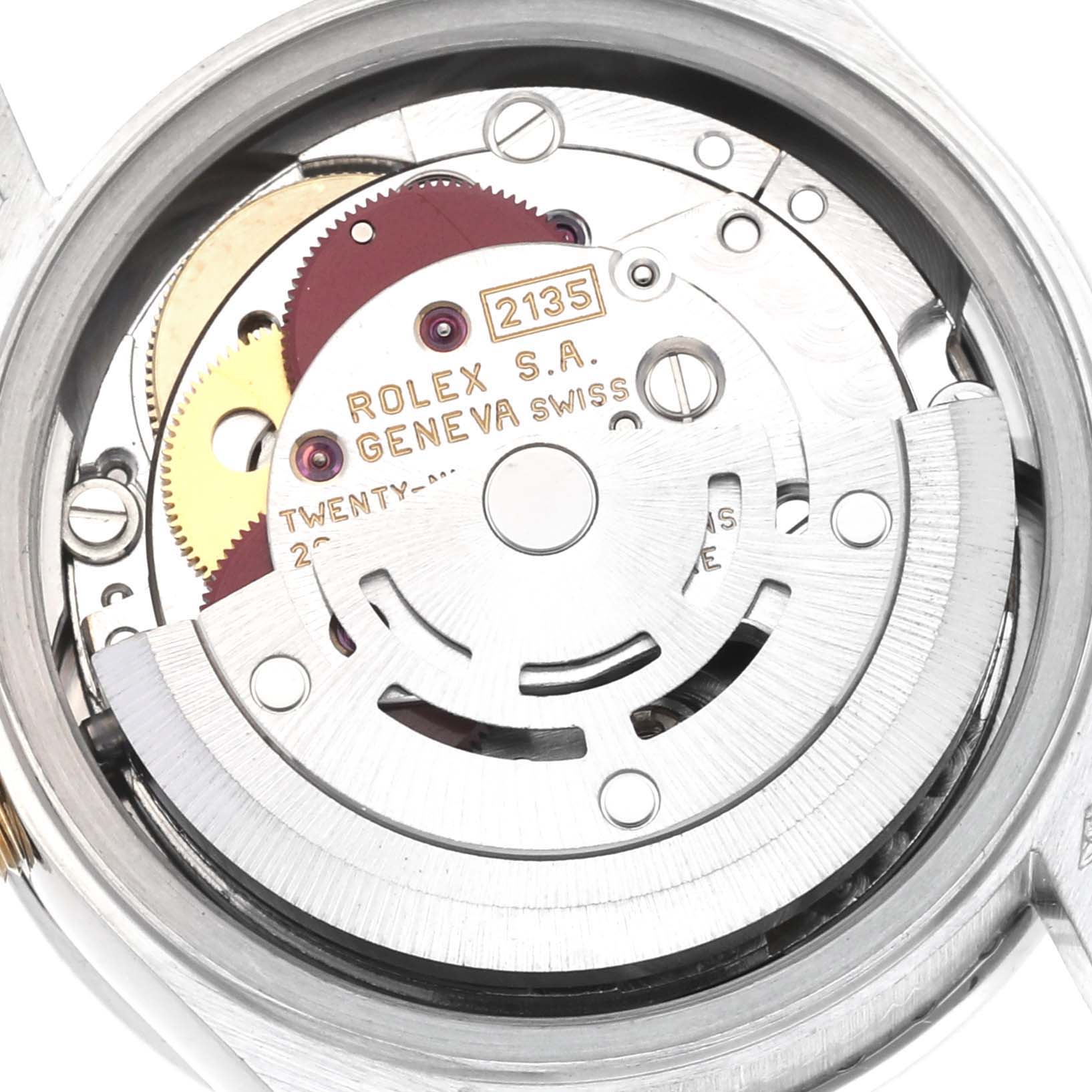 The image shows the movement of the Rolex President 69136 Women
s Platinum Silver Dial 69136 Women
s Platinum Silver Dial model viewed from the back, highlighting gears and the rotor.