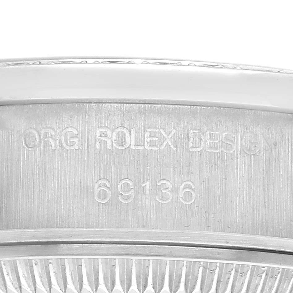 The image shows a close-up of the Rolex President 69136 Women
s Platinum Silver Dial 69136 Women
s Platinum Silver Dial watch model, focusing on the engraved model number and part of the bezel.